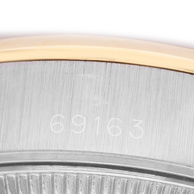 The image shows a close-up of the side of a Rolex Datejust 69163 Women's Steel and Gold (two tone) Beige Dial watch case, highlighting the serial number.