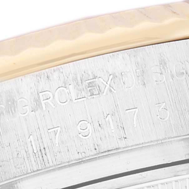 This image shows a close-up of the engraved serial and model number on the side of a Rolex Datejust 179173 Women's Steel and Gold (two tone) Silver Dial 179173 Women's Steel and Gold (two tone) Silver Dial watch case.
