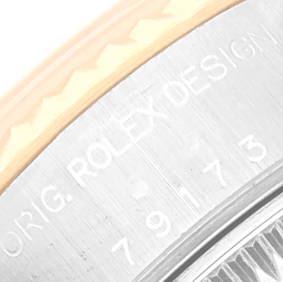 This image shows a close-up of the edge of the casing, with "Rolex Design" engraving, of a Rolex Datejust 79173 Women's Steel and Gold (two tone) Mother of Pearl Dial 79173 Women's Steel and Gold (two tone) Mother of Pearl Dial watch.