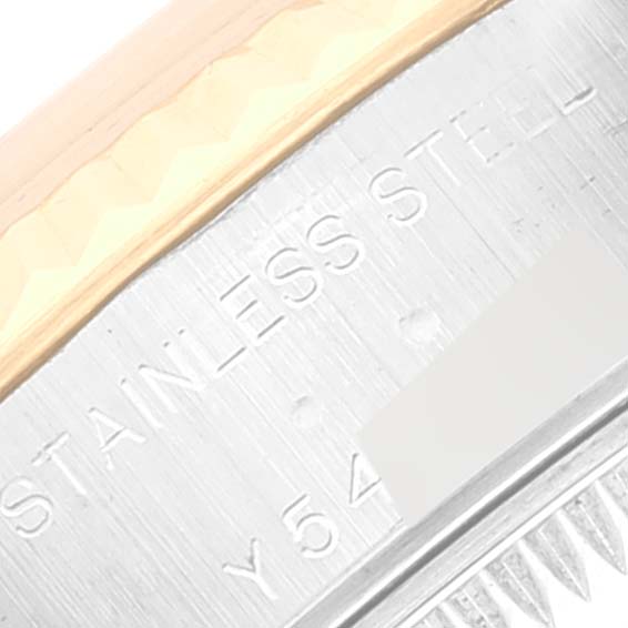 The image shows a close-up of the side of a Rolex Datejust 79173 Women's Steel and Gold (two tone) Mother of Pearl Dial 79173 Women's Steel and Gold (two tone) Mother of Pearl Dial model, highlighting "STAINLESS STEEL" engraving and a part of the bezel.