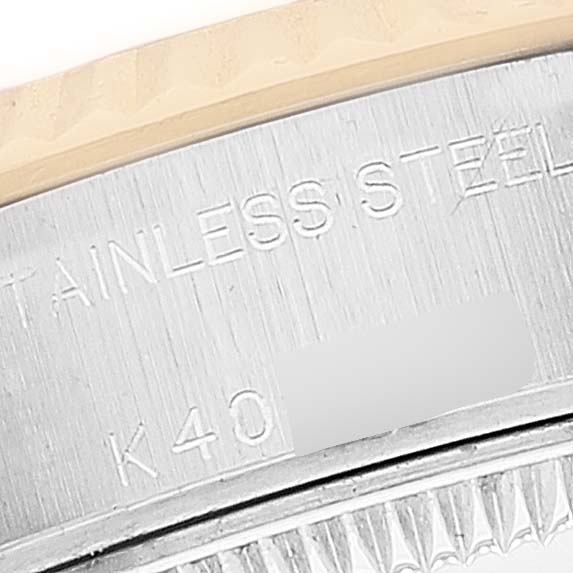 This close-up photo of a Rolex Datejust 79173 Women
s Steel and Gold (two tone) Mother of Pearl Dial 79173 Women
s Steel and Gold (two tone) Mother of Pearl Dial watch shows the engravings on its stainless steel case and part of the bezel.