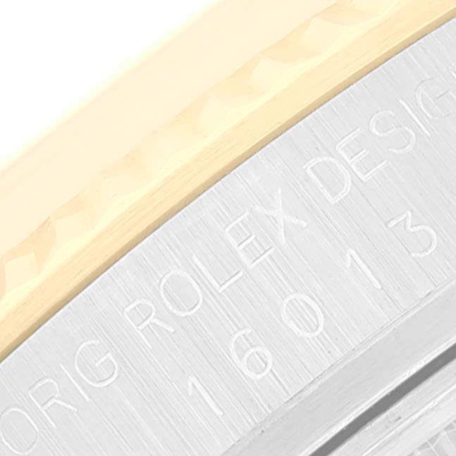 This image shows a close-up of the engraved side of the bezel and case on a Rolex Vintage Collection 16013 Men's Steel and Gold (two tone) White Dial 16013 Men's Steel and Gold (two tone) White Dial model.