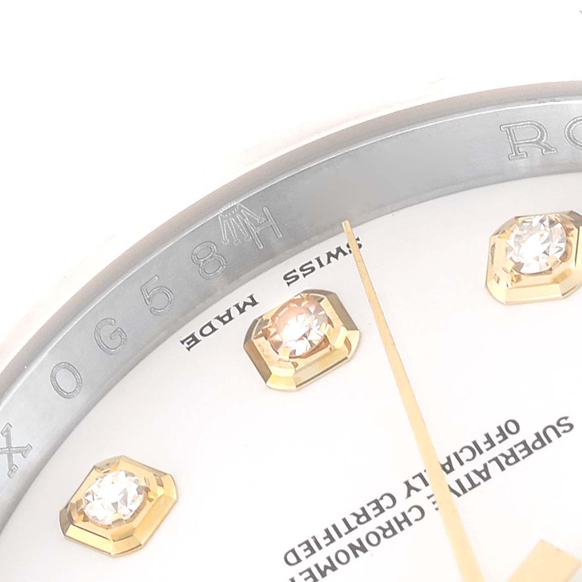 This close-up angle shows the dial and part of the bezel with diamonds and inscriptions on a Rolex Datejust 116233 Men's Steel and Gold (two tone) White Dial 116233 Men's Steel and Gold (two tone) White Dial watch.