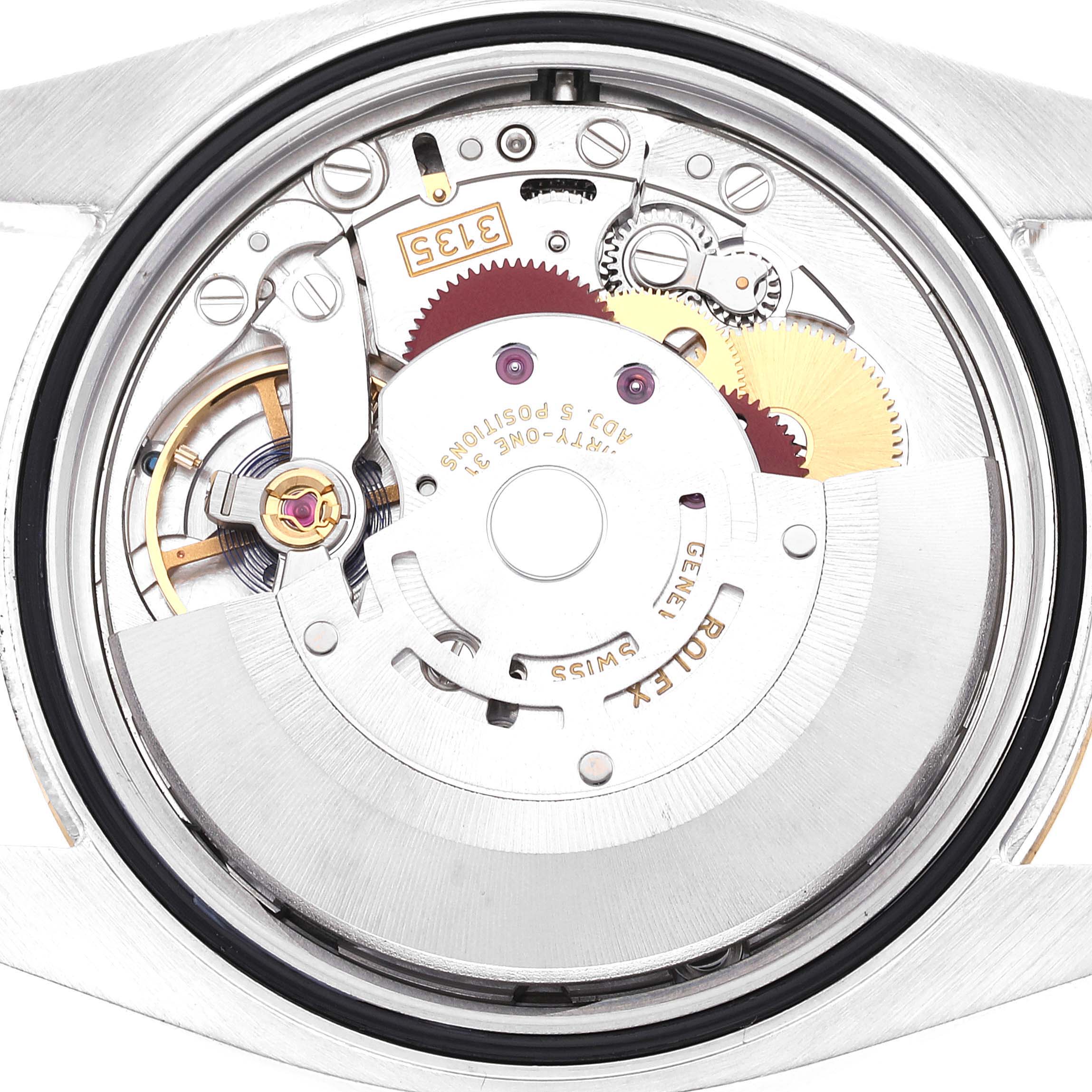 This close-up image shows the intricate inner mechanism of a Rolex Datejust 116233 Men's Steel and Gold (two tone) White Dial 116233 Men's Steel and Gold (two tone) White Dial watch, highlighting its gears and components.