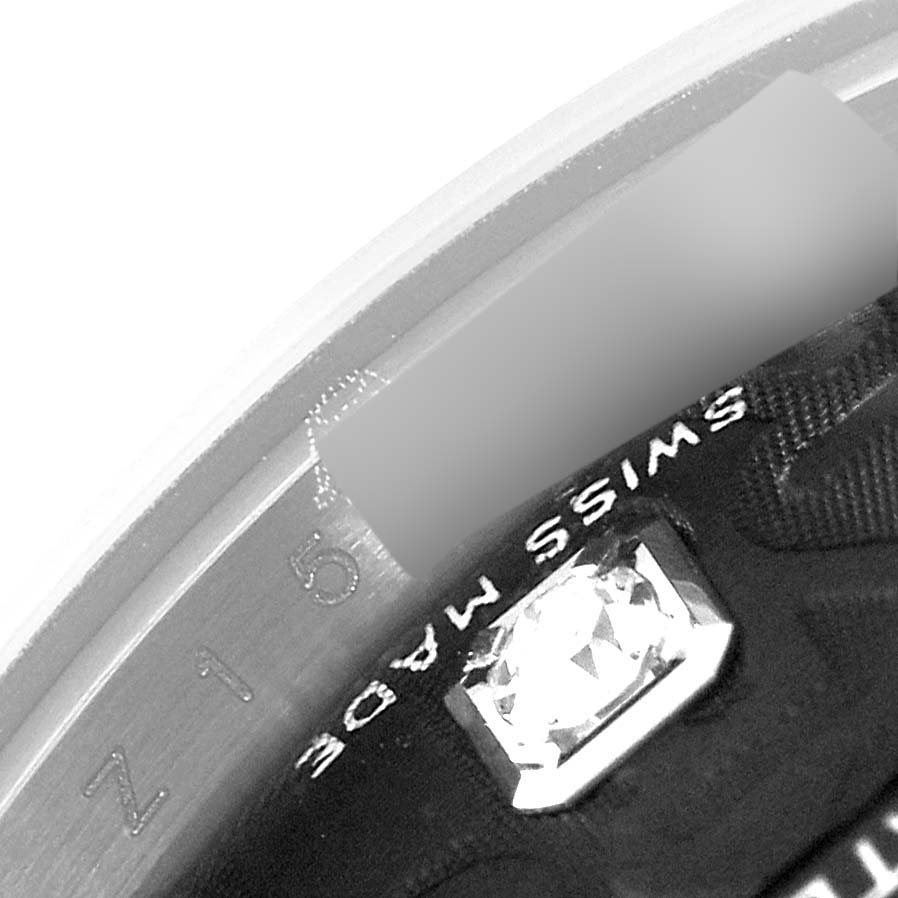 The image shows an angled close-up of the bezel and part of the dial of a Rolex Datejust 179174 Women's Stainless Steel Black Dial 179174 Women's Stainless Steel Black Dial watch, featuring "SWISS MADE" text.