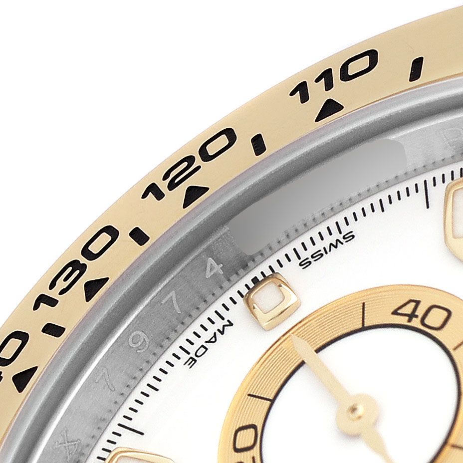 The image shows a close-up of the bezel and dial of a Rolex Daytona 116503 Men's Steel and Gold (two tone) White Dial watch, highlighting the tachymetric scale and part of the sub-dial.