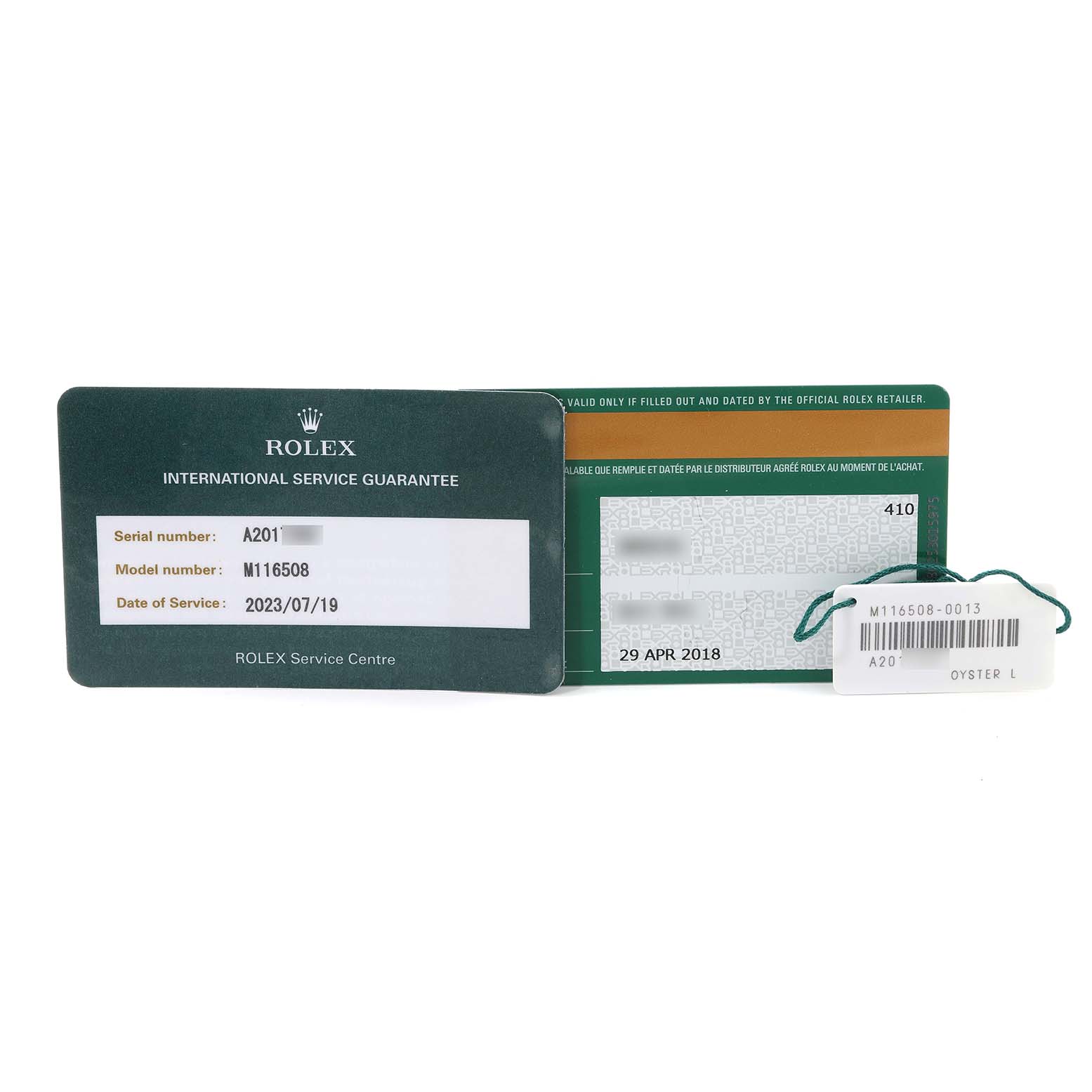 The image shows the international service guarantee card, warranty card, and hang tag for a Rolex Daytona 116508 Men
s Yellow Gold Green Dial 116508 Men
s Yellow Gold Green Dial model M116508.