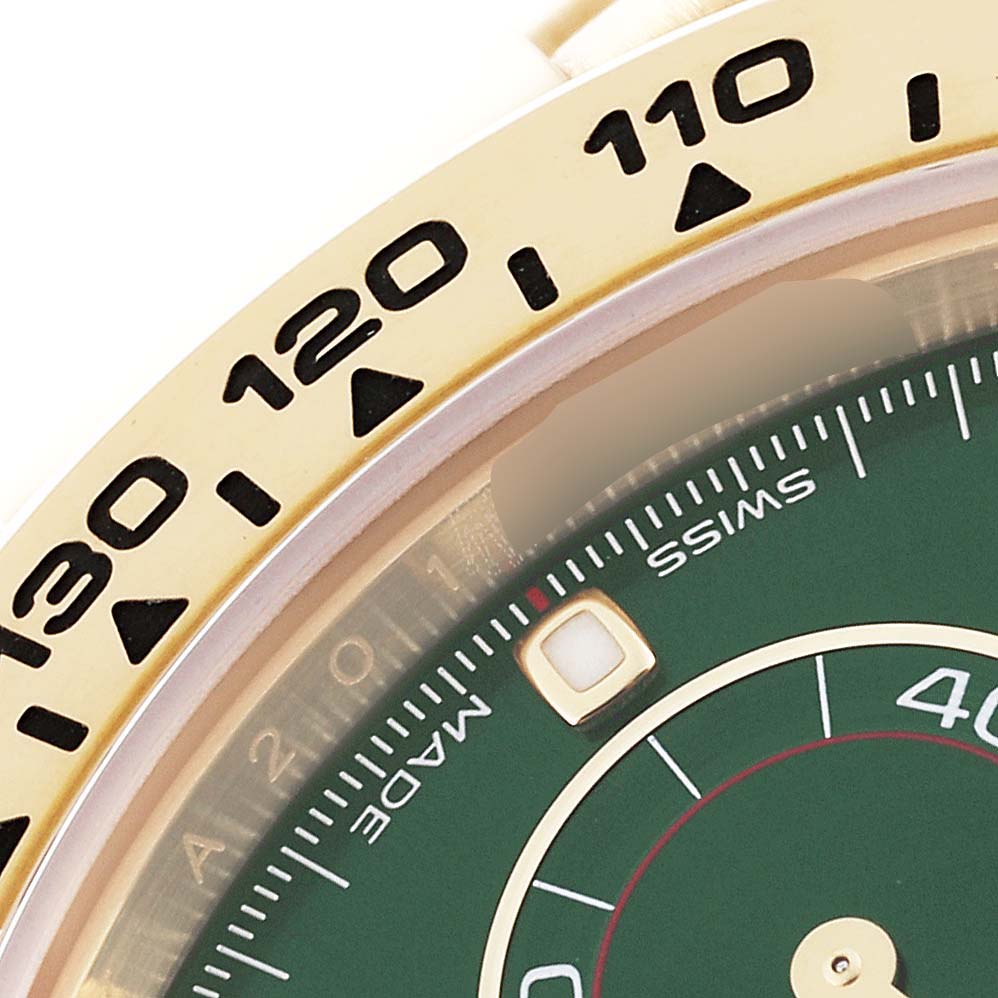 This close-up image shows the bezel and dial of a Rolex Daytona 116508 Men
s Yellow Gold Green Dial 116508 Men
s Yellow Gold Green Dial watch, highlighting the tachymeter scale and a portion of the green dial.