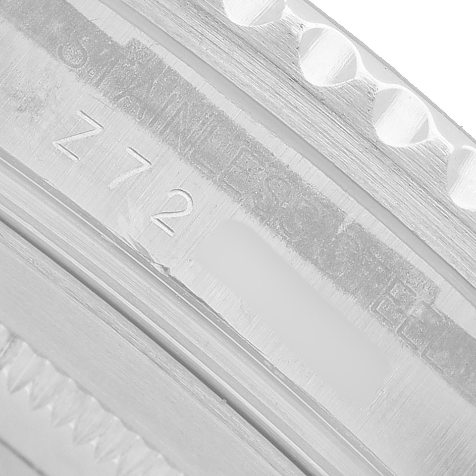 The image shows a close-up of the inside bezel engraving of a Rolex GMT-Master 16710 Men's Stainless Steel Black Dial, displaying "STAINLESS STEEL" and a partial serial or model number.