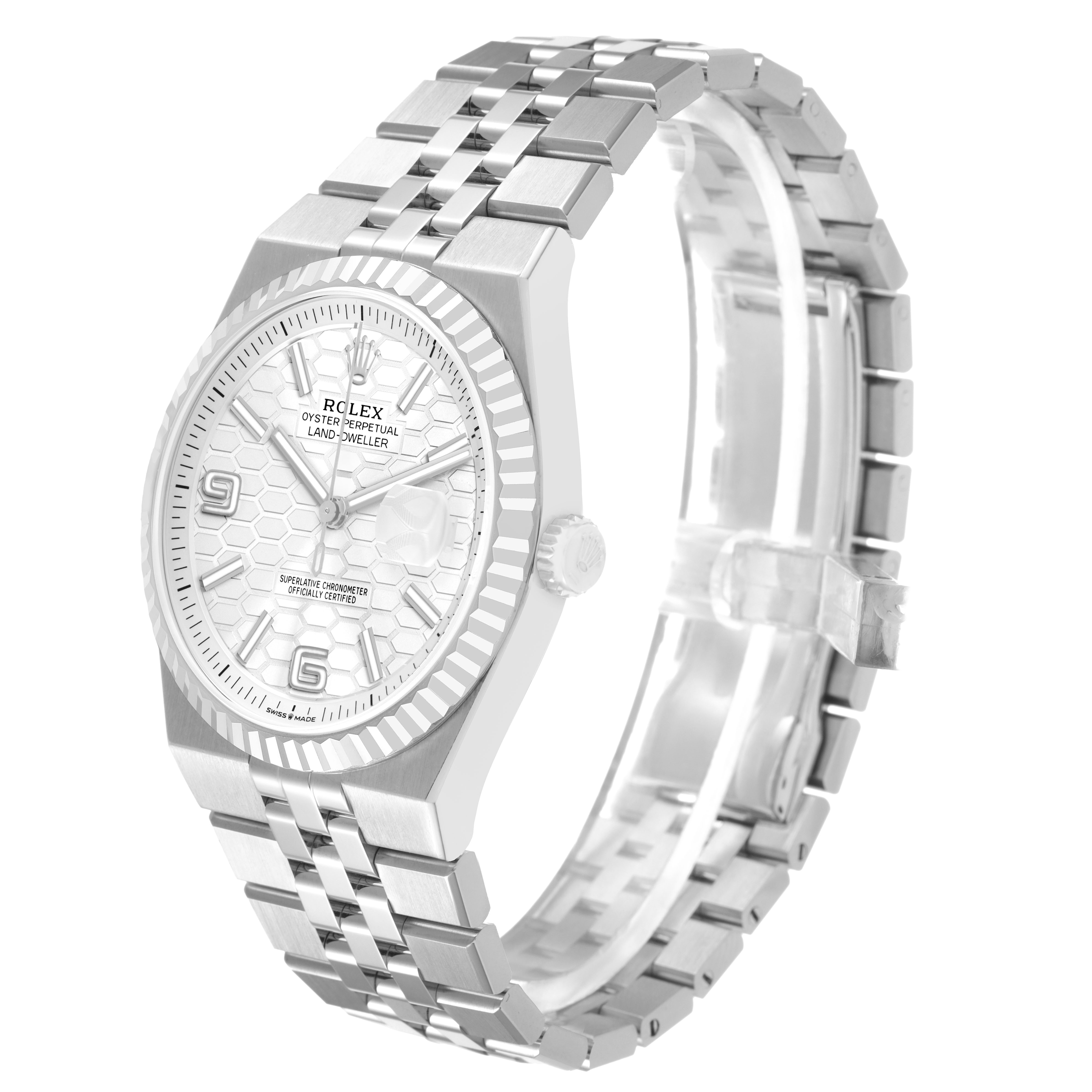 The image shows a Rolex Land-Dweller watch at a three-quarter angle, highlighting the face, bezel, and bracelet.
