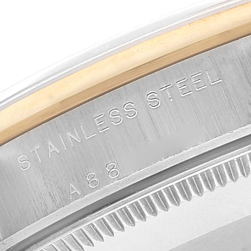 This is a close-up angle of the stainless steel case back of a Rolex Mid-Size 77483 Women
s Steel and Gold (two tone) Grey Dial 77483 Women
s Steel and Gold (two tone) Grey Dial model watch.