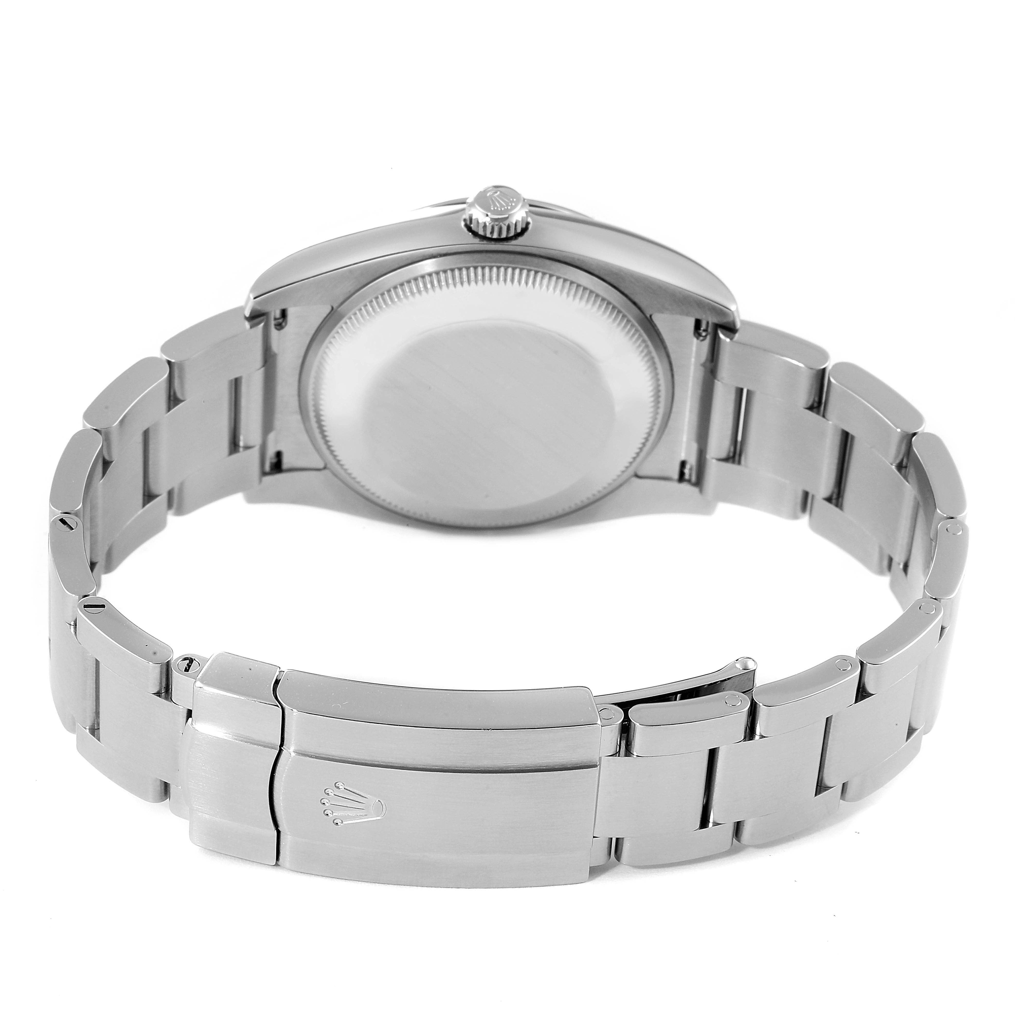 The image shows the back view of a Rolex Oyster Perpetual 114200 Men's Stainless Steel Champagne Dial 114200 Men's Stainless Steel Champagne Dial watch, highlighting the clasp and bracelet.