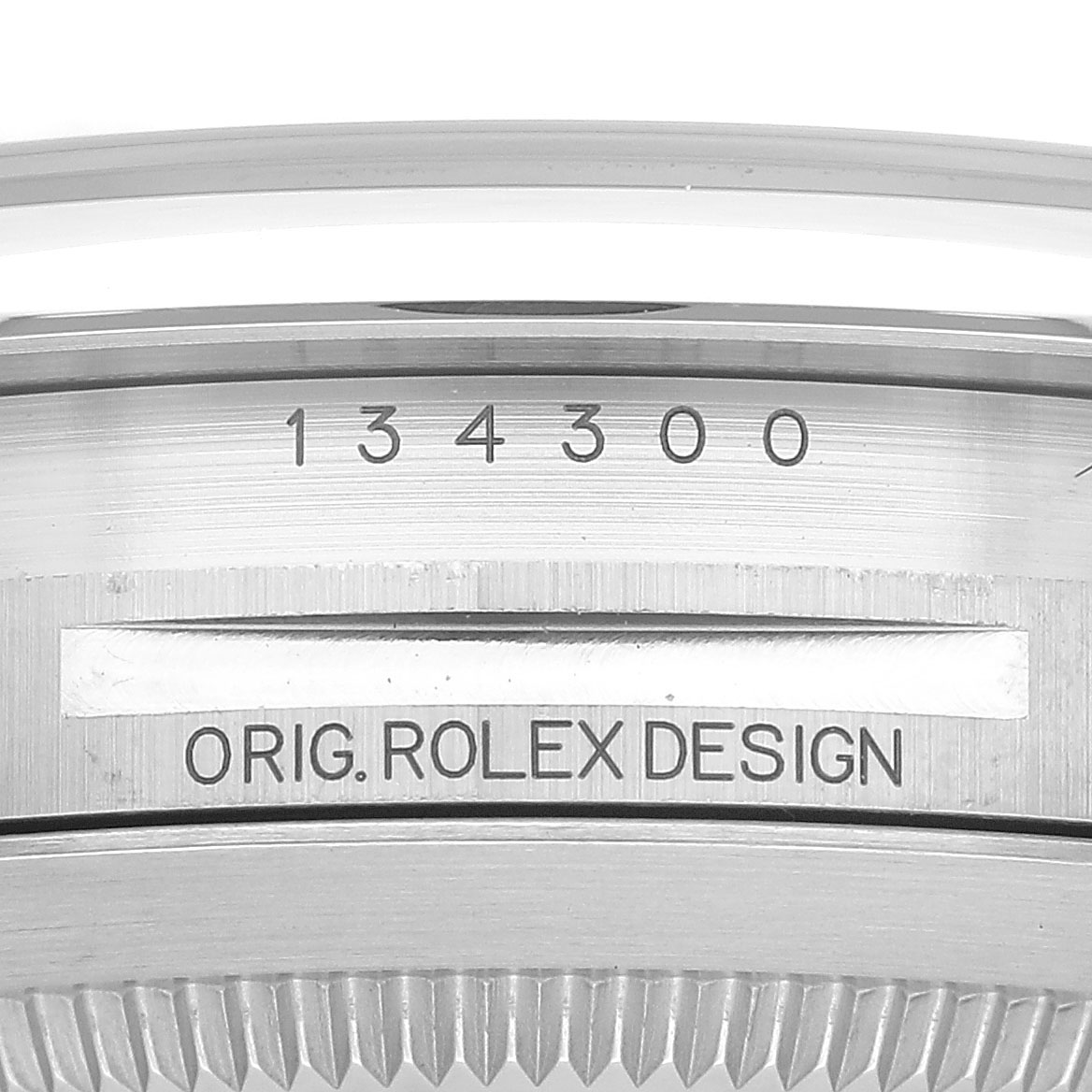 The image shows the side view of a Rolex Oyster Perpetual 134300 Men's Stainless Steel Beige Dial, highlighting the model number and "Orig. Rolex Design" engraving.