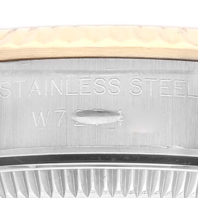 The image shows a close-up view of the case back edge of a Rolex Oyster Perpetual 67193 Women
s Steel and Gold (two tone) Champagne Dial 67193 Women
s Steel and Gold (two tone) Champagne Dial watch, highlighting its stainless steel material.