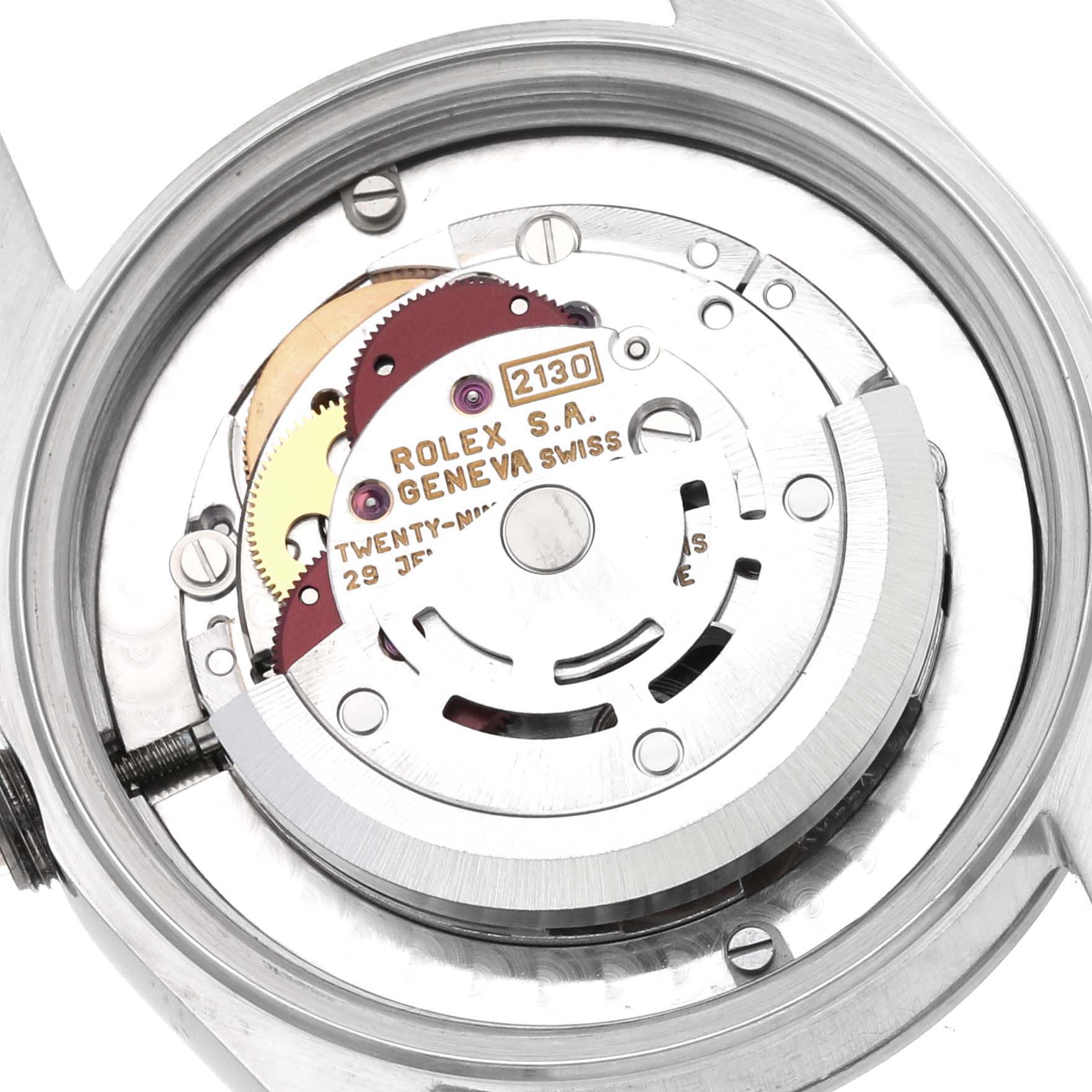 The image shows the movement of a Rolex Mid-Size 67480 Women's Stainless Steel Black Dial 67480 Women's Stainless Steel Black Dial model from the back, highlighting the gears and rotor.