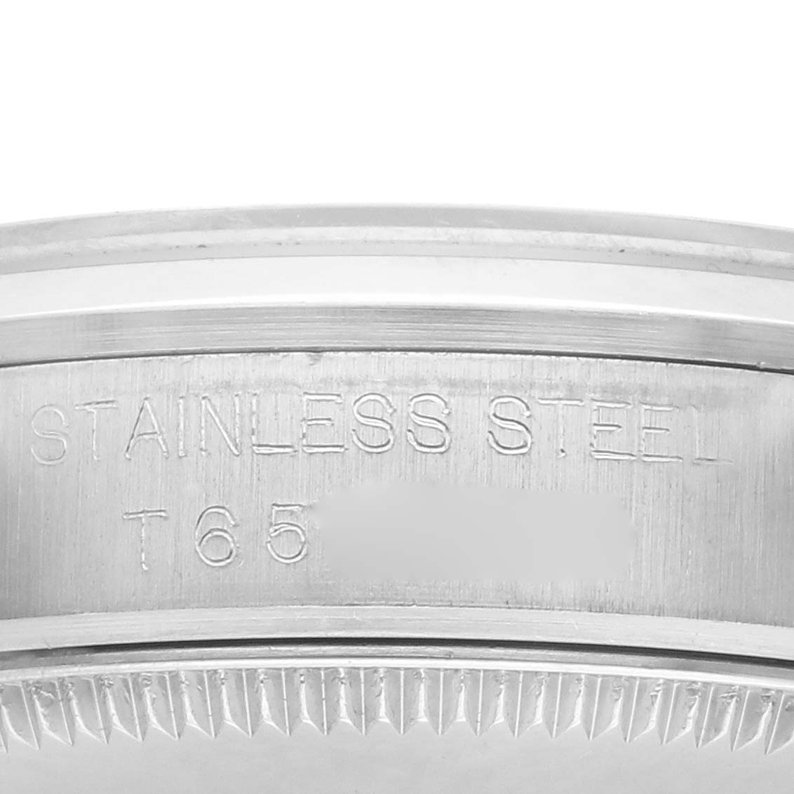 The image shows a close-up of the side engraving on a Rolex Mid-Size 67480 Women's Stainless Steel Black Dial 67480 Women's Stainless Steel Black Dial watch, indicating "STAINLESS STEEL."