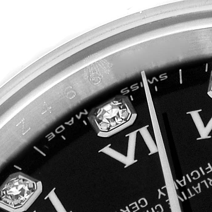 This close-up image of a Rolex Oyster Perpetual 176234 Women's Stainless Steel Black Dial 176234 Women's Stainless Steel Black Dial watch shows part of the bezel, the minute hand, and diamond hour markers.