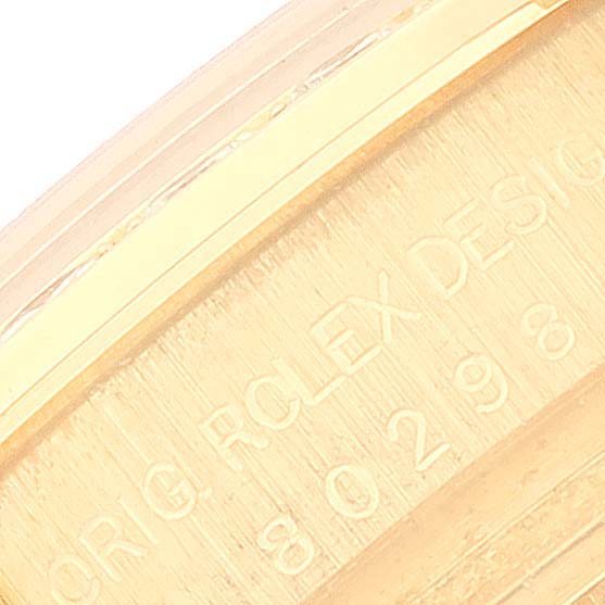 Close-up of the side of the Rolex Pearlmaster 80298 Women's Yellow Gold Champagne Dial 80298 Women's Yellow Gold Champagne Dial, showing engraving details.