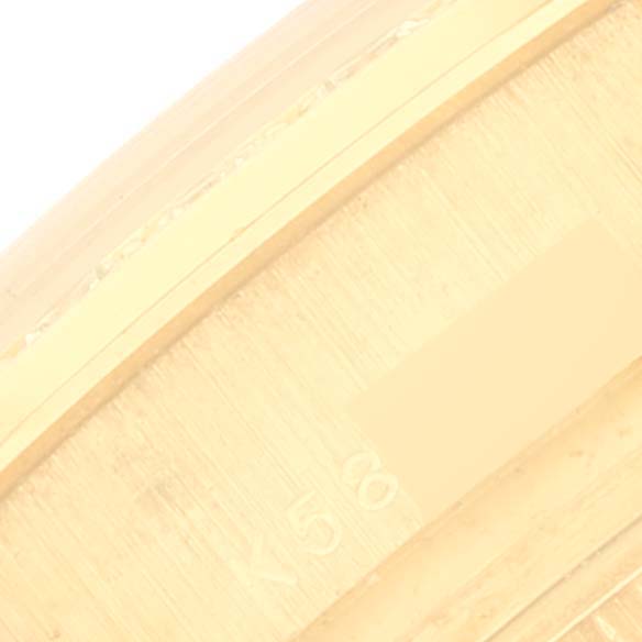 The image shows a close-up of the side of a Rolex Pearlmaster 80298 Women's Yellow Gold Champagne Dial 80298 Women's Yellow Gold Champagne Dial watch, focusing on part of the band or bezel.