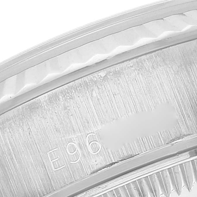 This close-up image shows the engraved serial number on a Rolex President 69179 Women's White Gold Silver Dial 69179 Women's White Gold Silver Dial model's case.