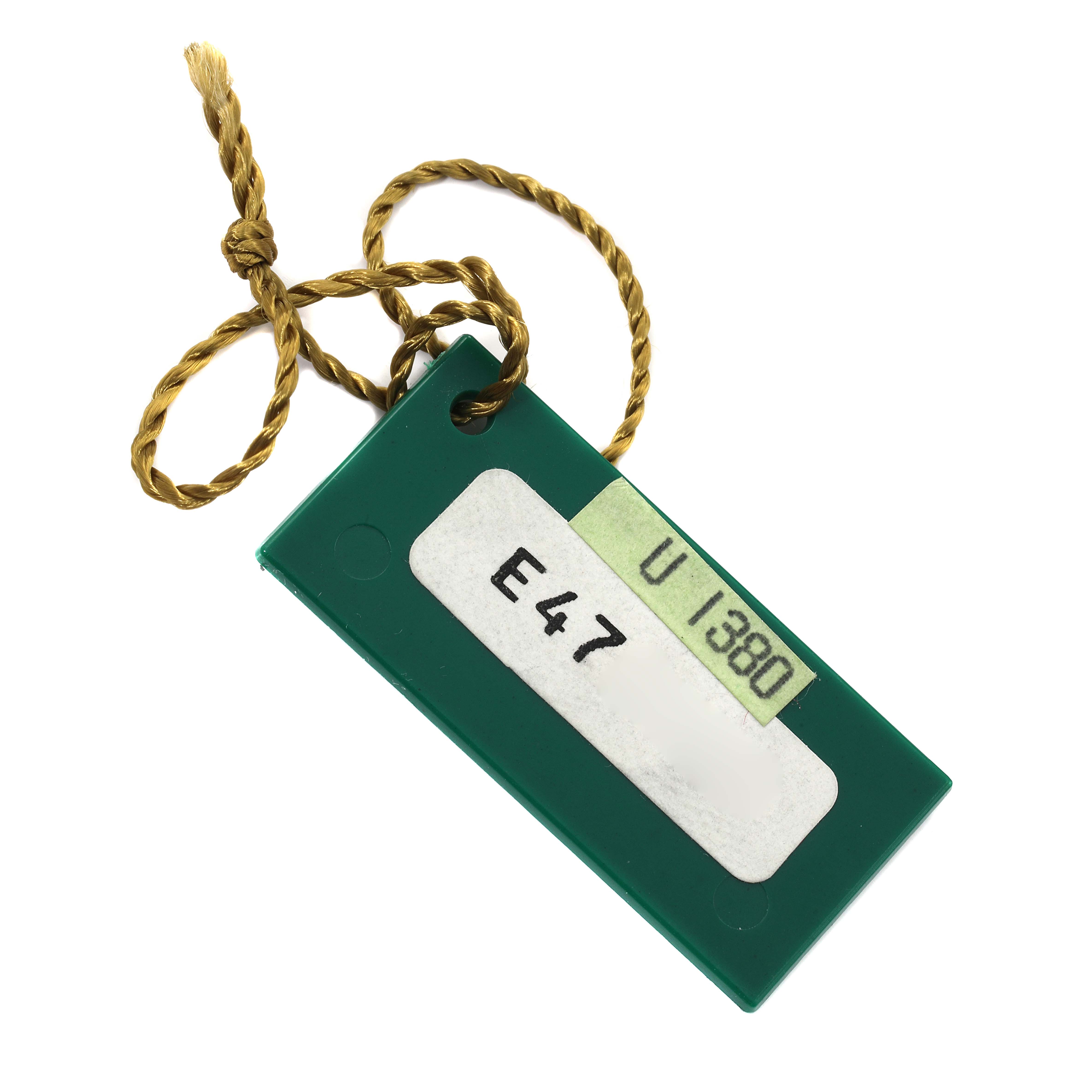 The image shows a green Rolex hang tag with a golden string, related to the President model.
