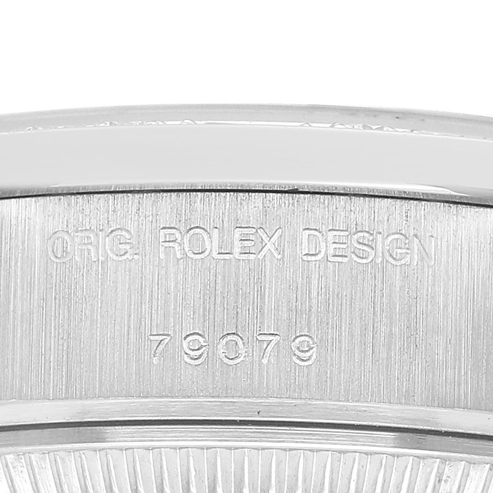 The image shows the side view of a Rolex President 79079 Women's White Gold Silver Dial watch with the "ORG. ROLEX DESIGN" and model number engraved.