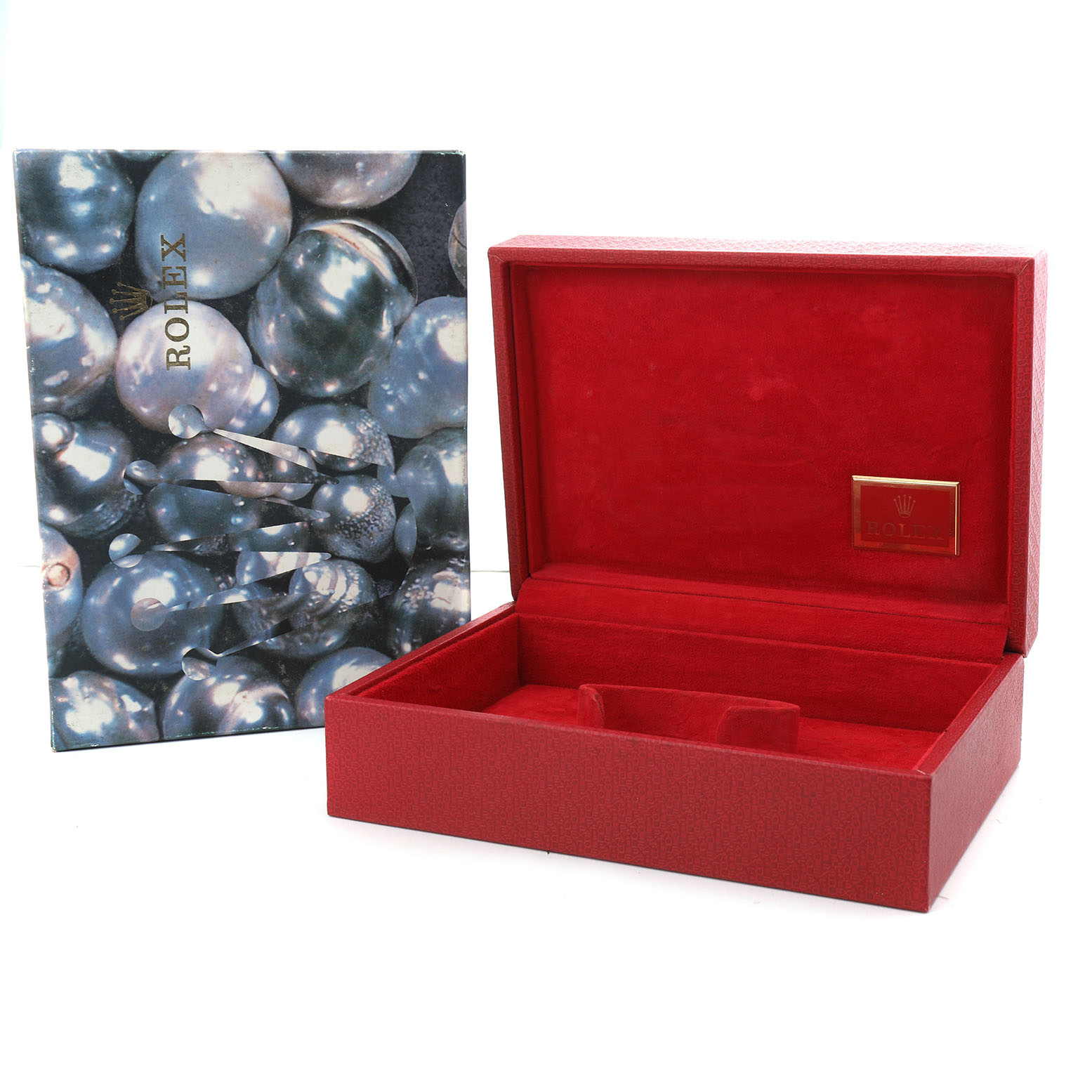 The image shows an open red Rolex watch box and a booklet with a pearl design, viewed from the top front angle.