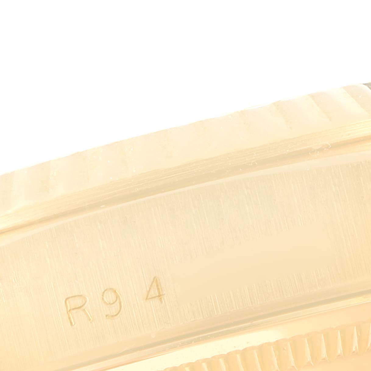 The image shows a close-up of the side case detailing and engraving (R94) of a Rolex President 18238 Men's Yellow Gold Champagne Dial 18238 Men's Yellow Gold Champagne Dial model watch.