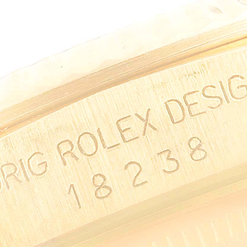 This image shows a close-up of the serial number and "ROLEX" engraving on the side of a Rolex President 18238 Men's Yellow Gold Champagne Dial 18238 Men's Yellow Gold Champagne Dial model.