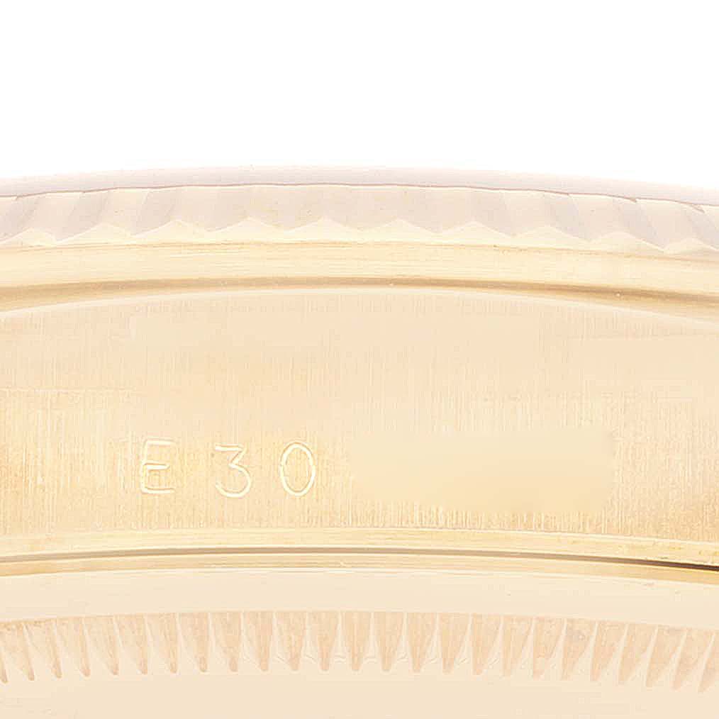 This close-up shows the side of a President model Rolex watch, focusing on the engraved serial number.