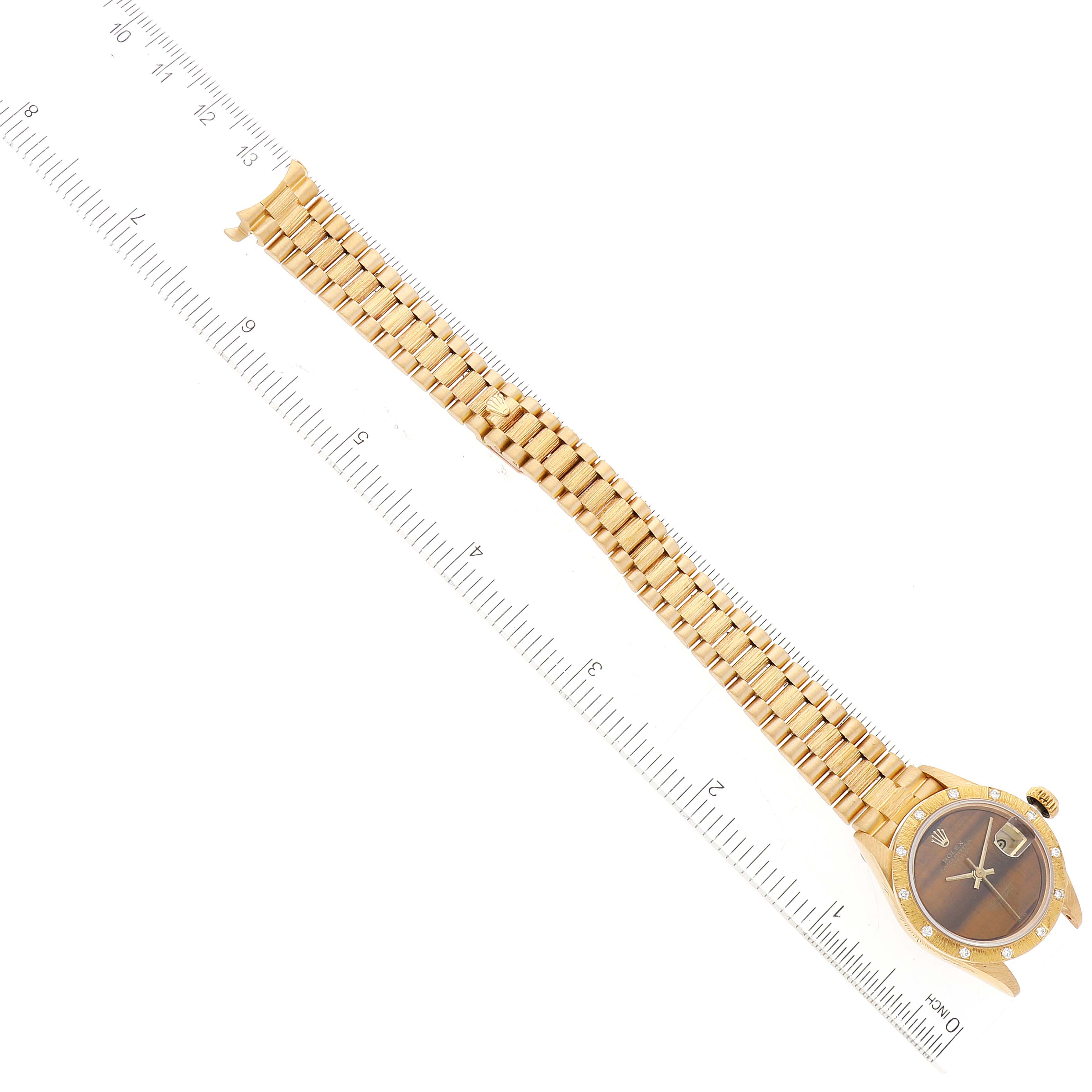 The image shows the full length of a Rolex President 69288 Women's Yellow Gold Brown Dial 69288 Women's Yellow Gold Brown Dial model watch laid flat with a ruler for scale.