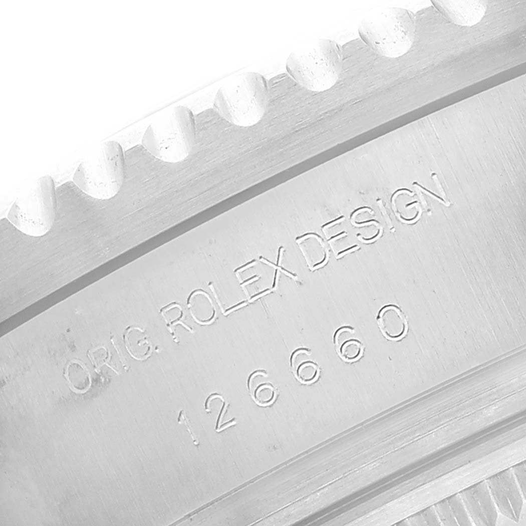 This close-up image shows the engraved serial number and "ORIG ROLEX DESIGN" text on the bezel of a Rolex Sea-Dweller 126660 Men
s Stainless Steel Blue Dial 126660 Men
s Stainless Steel Blue Dial watch.