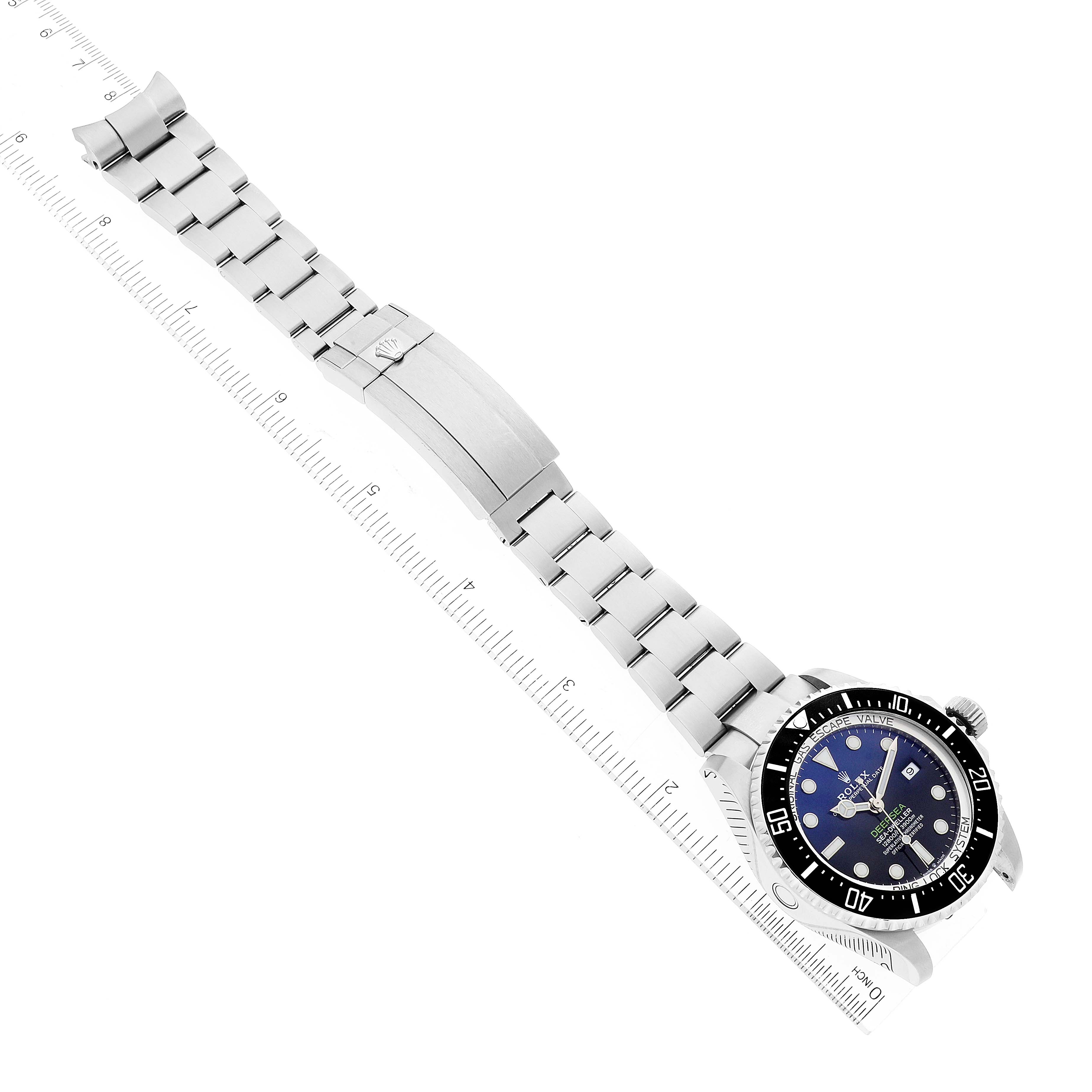 The image shows a Rolex Sea-Dweller 126660 Men
s Stainless Steel Blue Dial 126660 Men
s Stainless Steel Blue Dial watch laid flat with a ruler measuring its length.