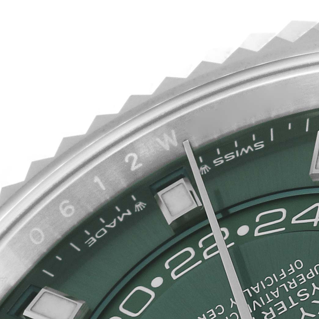 This close-up of the Rolex Sky-Dweller 336934 Men
s Stainless Steel Green Dial 336934 Men
s Stainless Steel Green Dial watch shows the bezel, part of the dial, and the hour markers.