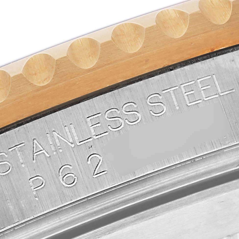 The image shows a close-up of the Rolex Submariner 16613 Men's Steel and Gold (two tone) Blue Dial 16613 Men's Steel and Gold (two tone) Blue Dial's bezel and engraved stainless steel markings.