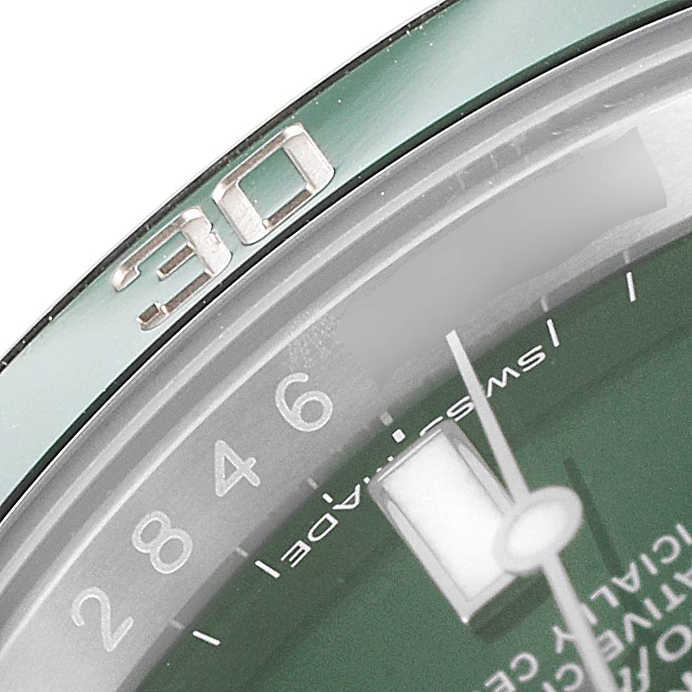 The image shows a close-up of the 30-minute marker and part of the green dial on a Rolex Submariner 116610LV Men
s Stainless Steel Green Dial 116610LV Men
s Stainless Steel Green Dial watch.