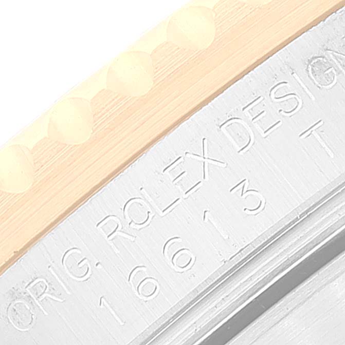 The image shows a close-up of the bezel and engraved model number of a Rolex Submariner 16613 Men
s Steel and Gold (two tone) Black Dial 16613 Men
s Steel and Gold (two tone) Black Dial.