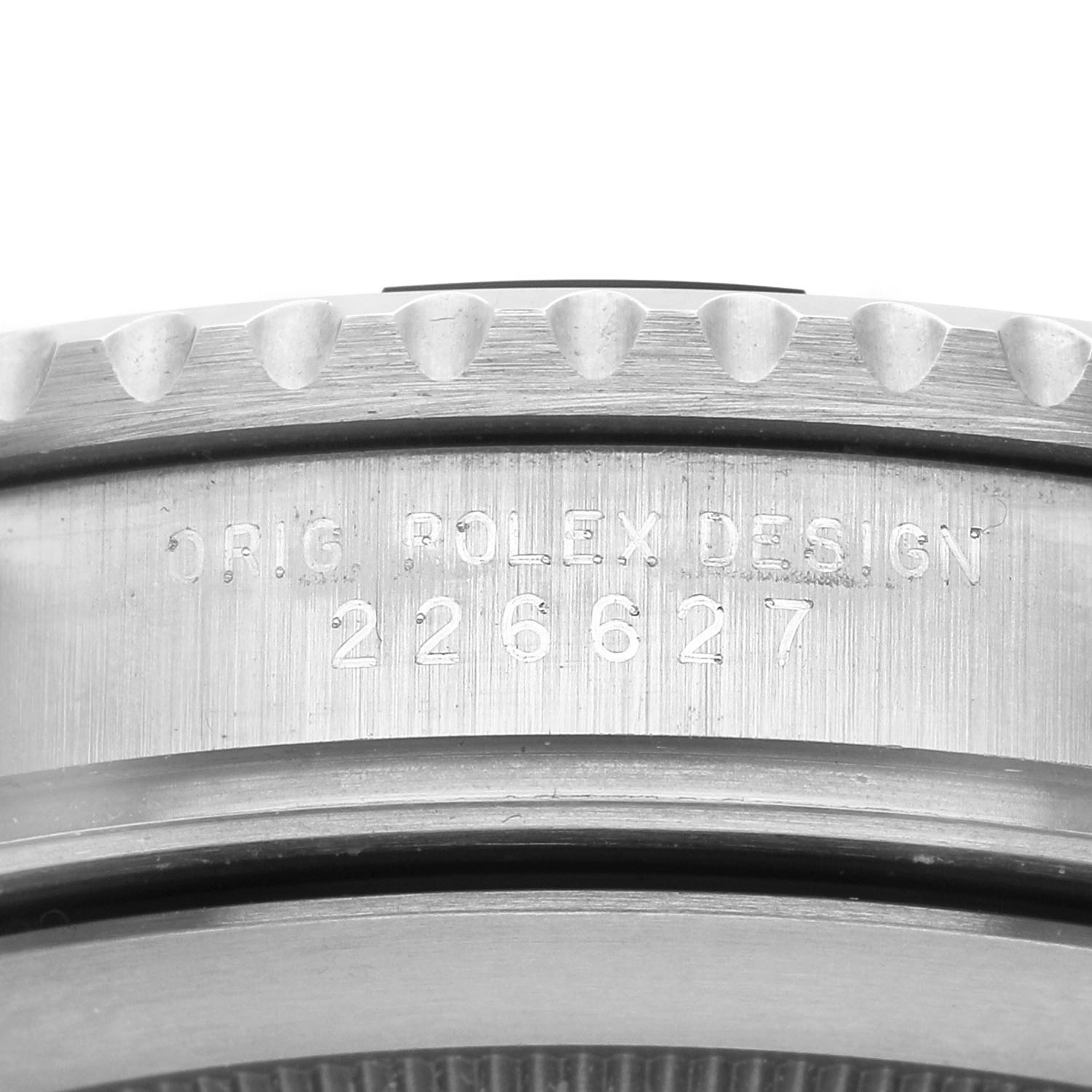 The image shows a close-up of the Rolex Yacht-Master 226627 Men's Titanium Black Dial's case side, featuring engraved text and a portion of the bezel.