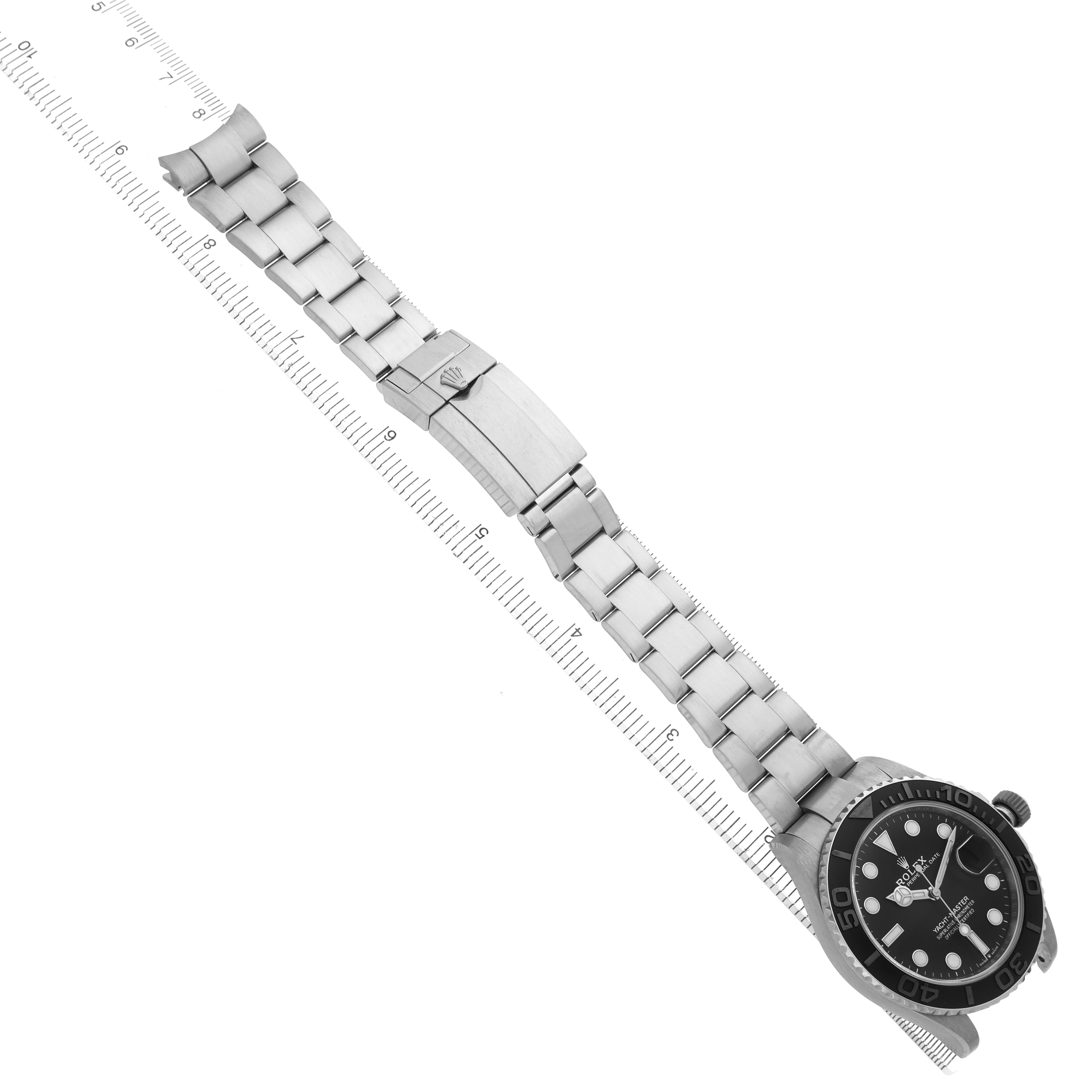 The Rolex Yacht-Master 226627 Men's Titanium Black Dial watch is shown from above, displaying the bracelet, clasp, and face alongside a ruler.