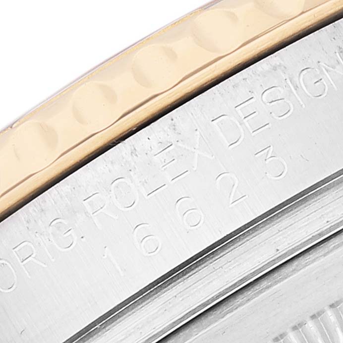 This close-up of the Rolex Yacht-Master 16623 Men
s Stainless Steel White Dial 16623 Men
s Stainless Steel White Dial watch showcases partial bezel and engraved serial number.