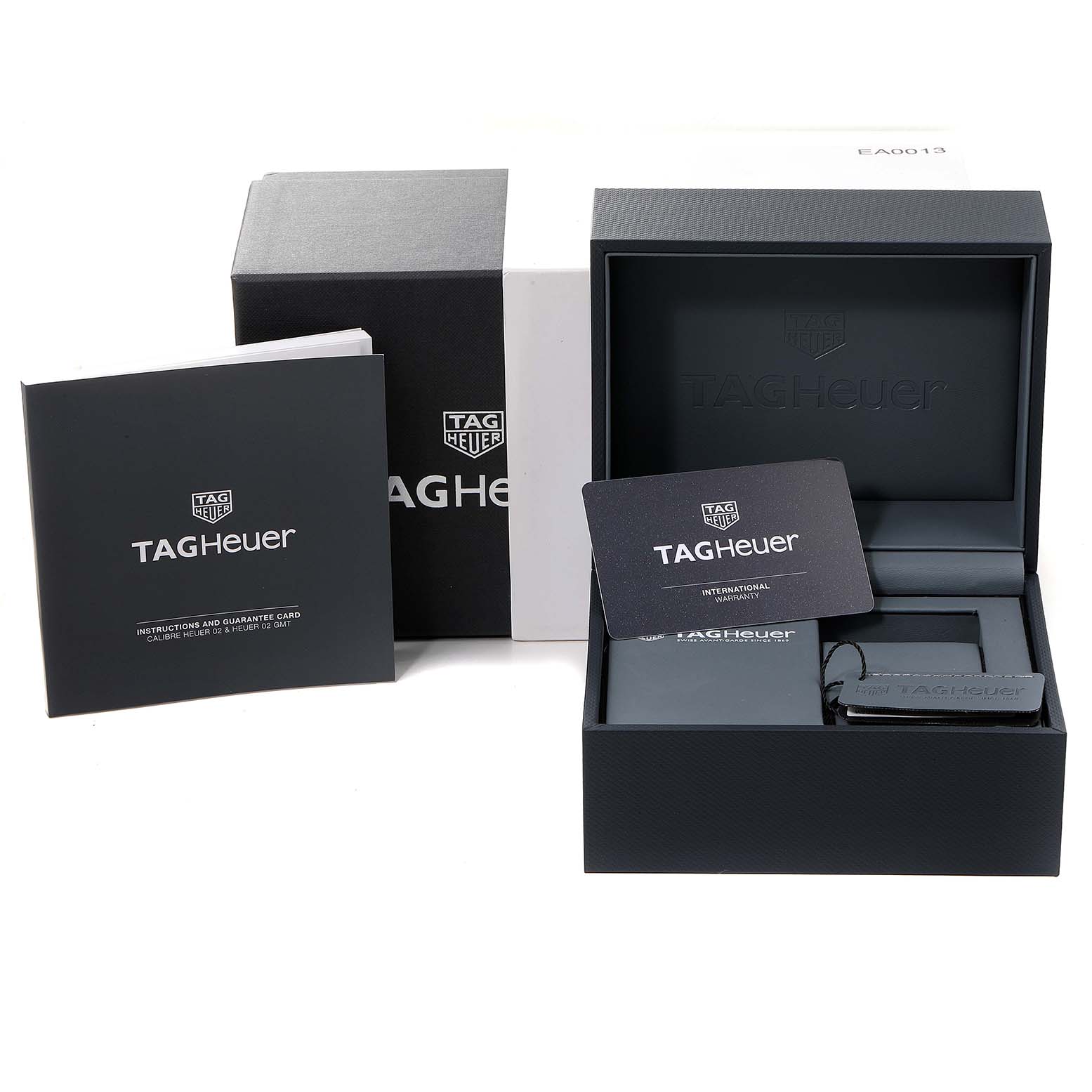 The image shows the packaging, instruction manual, and warranty card for the Tag Heuer Monaco CBL2113 Men's Stainless Steel Black Dial CBL2113 Men's Stainless Steel Black Dial model watch.