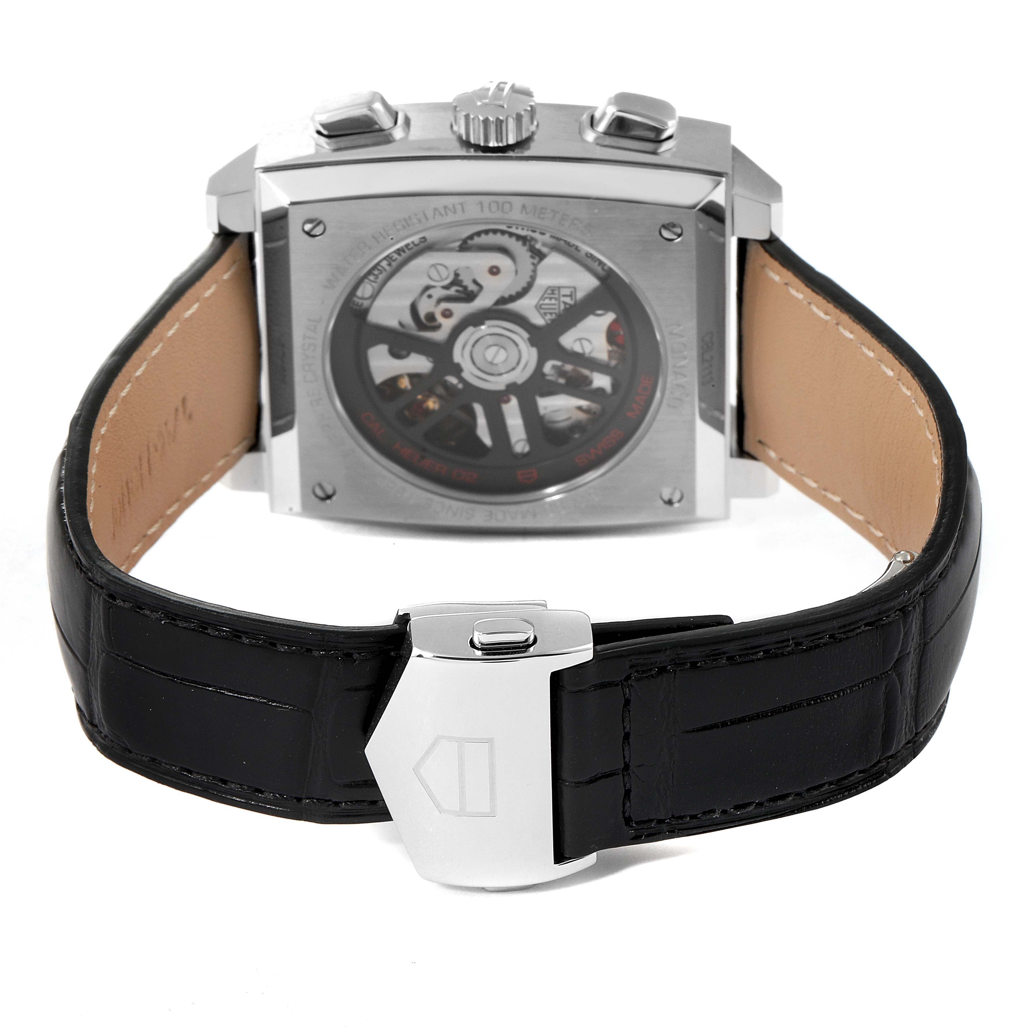 The image shows the back view of the Tag Heuer Monaco CBL2113 Men's Stainless Steel Black Dial CBL2113 Men's Stainless Steel Black Dial watch, displaying its case back, crown, and black leather strap with a clasp.