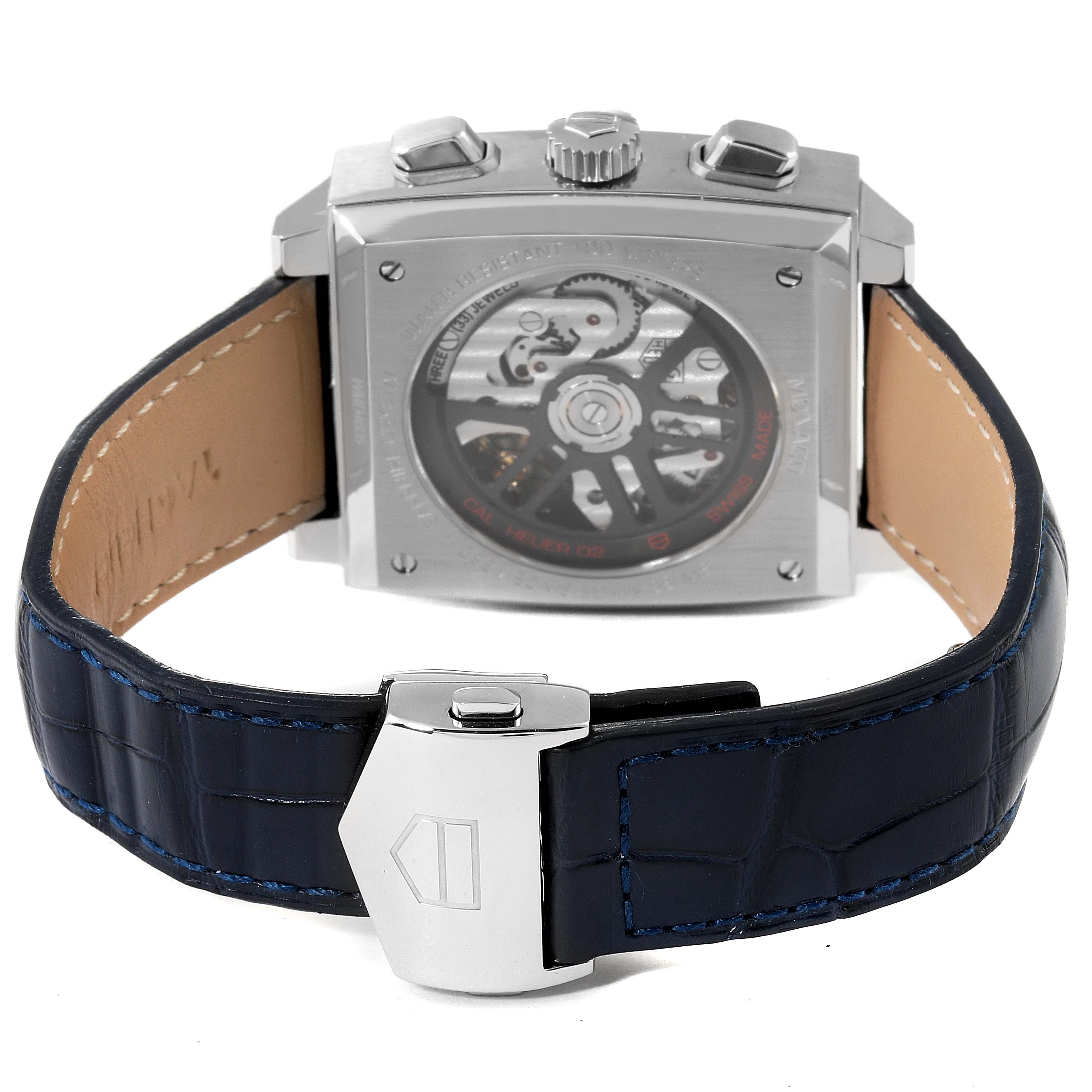 The image shows the back view of a Tag Heuer Monaco CBL2111.FC6453 Men's Stainless Steel Blue Dial CBL2111.FC6453 Men's Stainless Steel Blue Dial watch, including its leather strap and transparent case back displaying the movement.