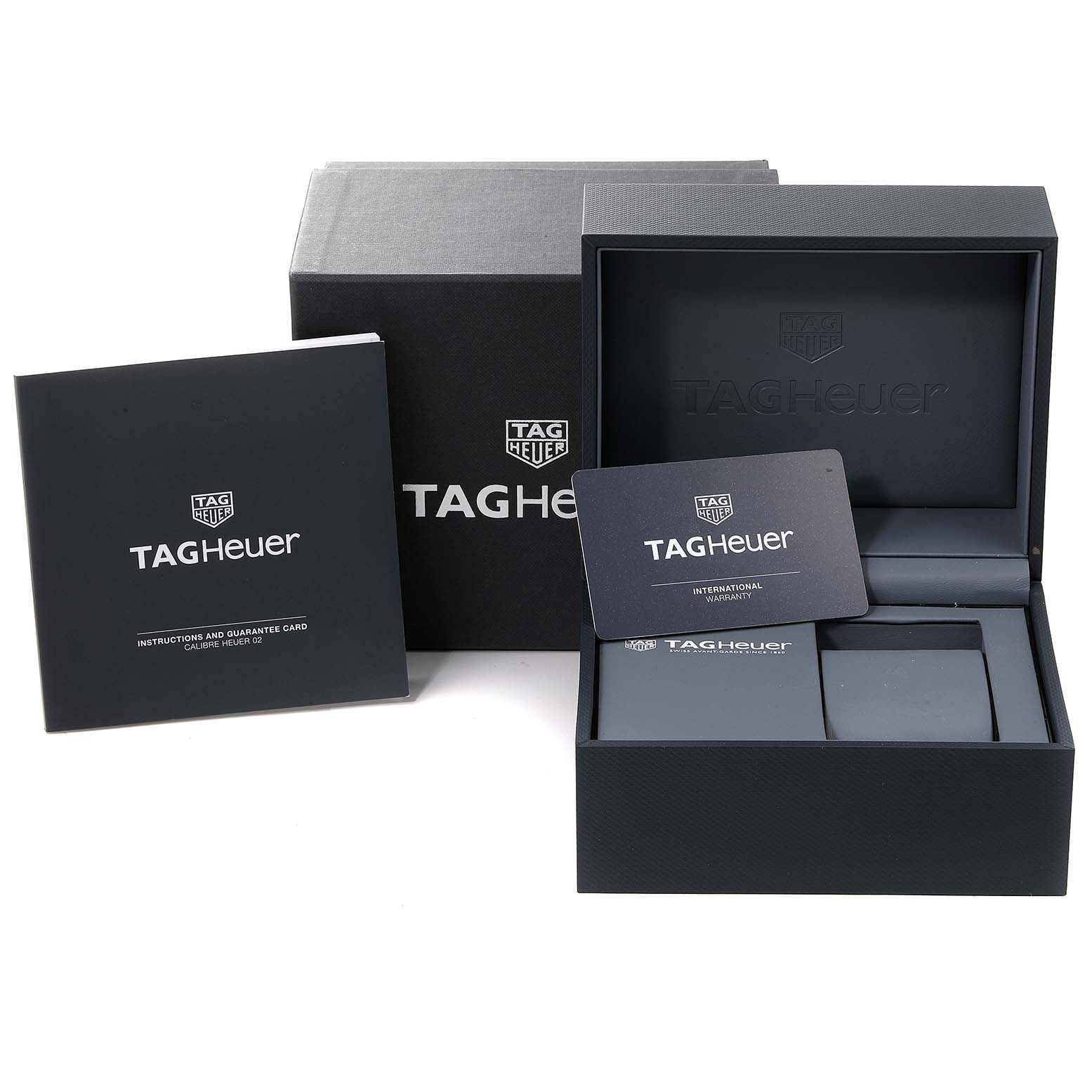 The image shows the packaging and warranty accessories for the Monaco model by Tag Heuer, including the box, card, and booklet.