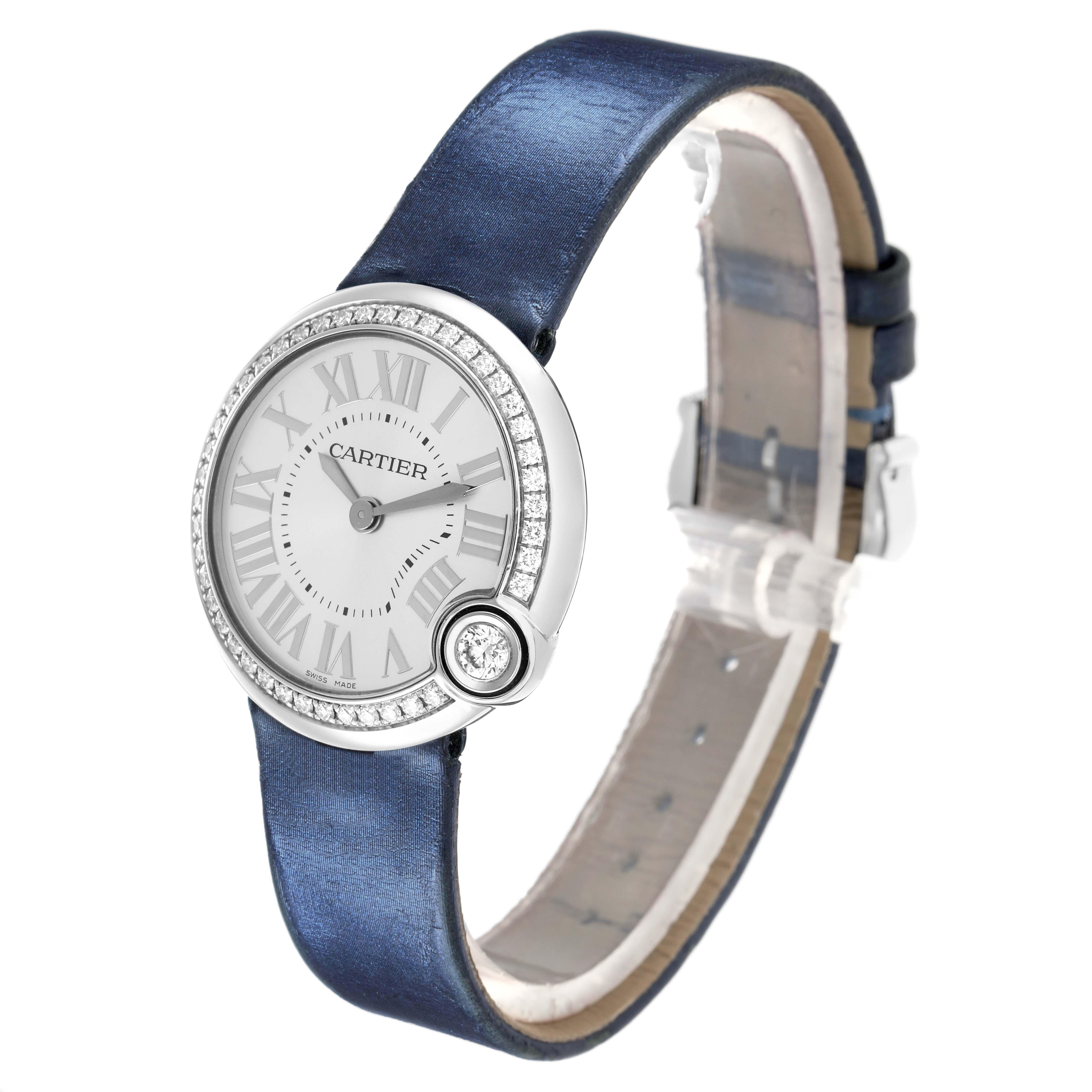 The Cartier Ballon Blanc W4BL0003 Women
s Stainless Steel Silver Dial watch is shown at a three-quarter angle, highlighting its dial, diamond bezel, and blue strap.