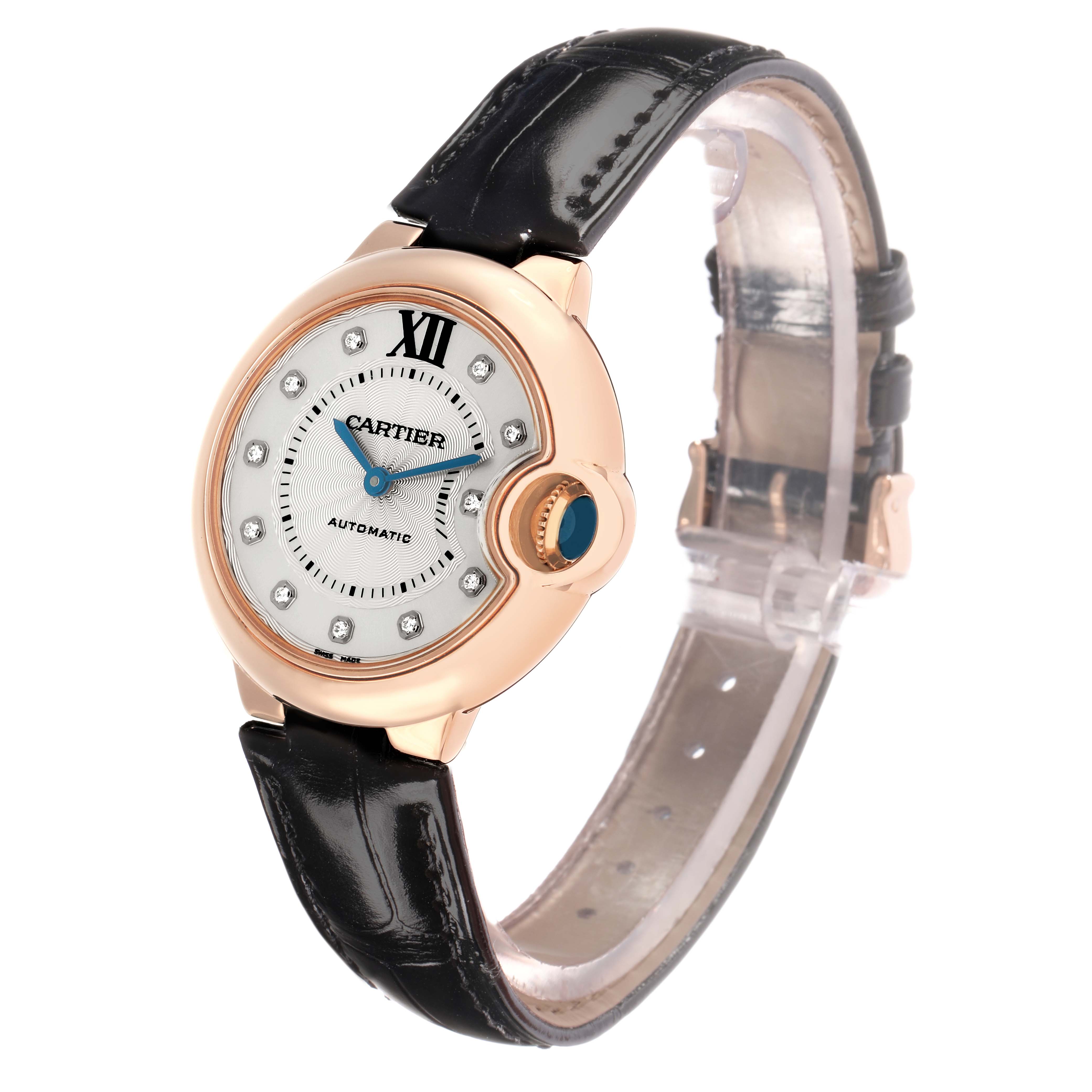 The Ballon Bleu de Cartier watch is shown at a three-quarter angle, displaying the face, strap, and distinctive crown.