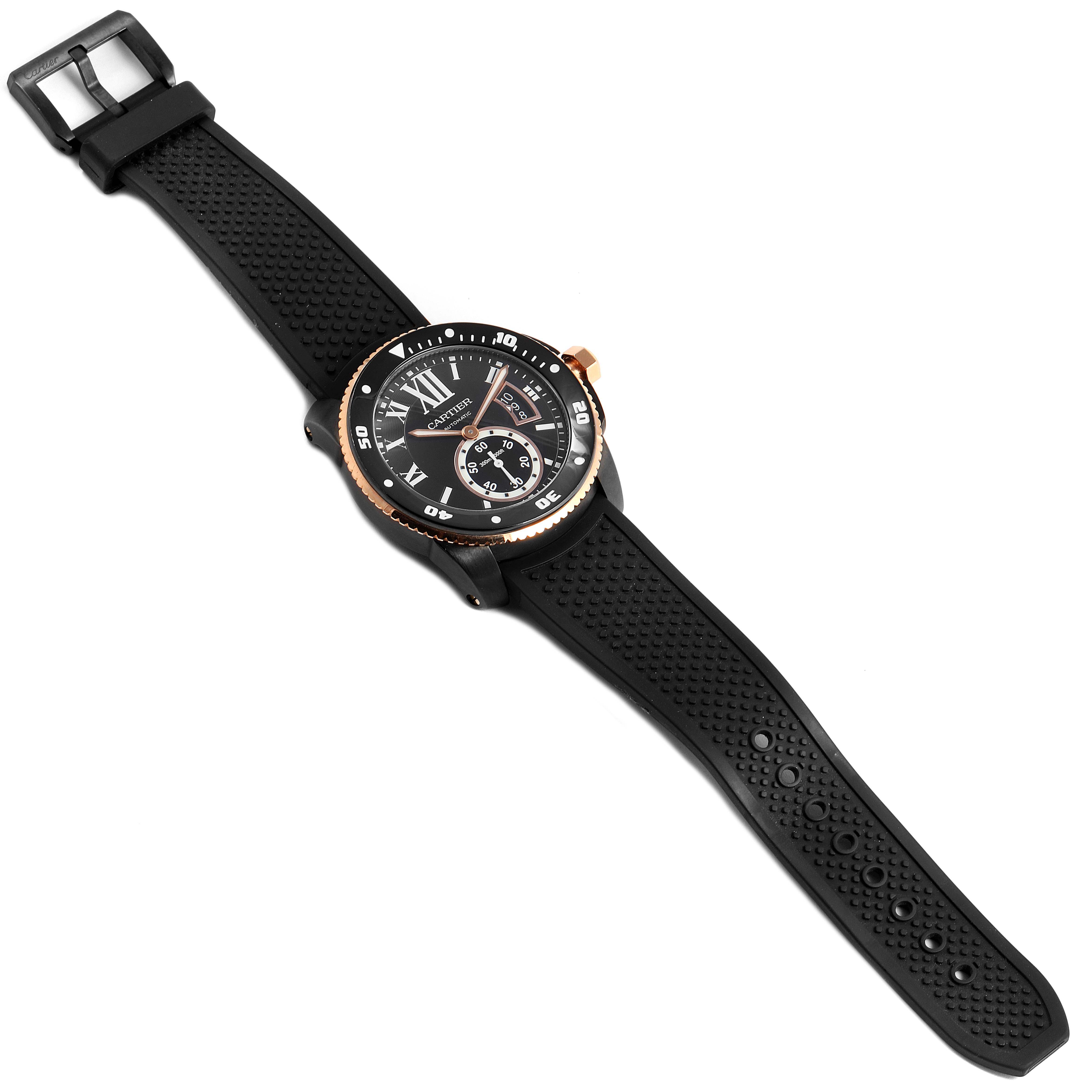 The image shows an angled top view of a Calibre de Cartier watch by Cartier, displaying the face, bezel, and black rubber strap.