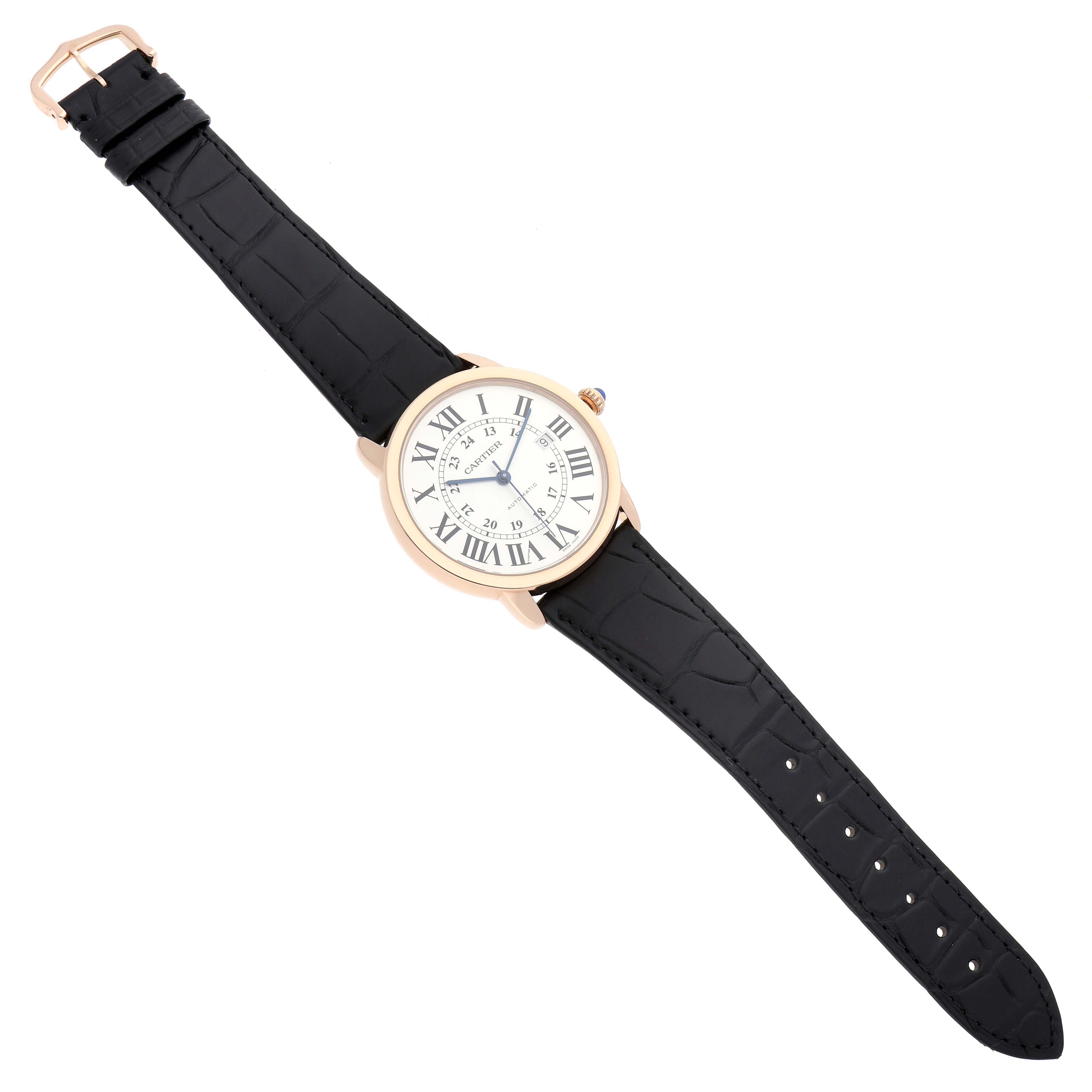 The Ronde model by Cartier is shown from a top-down view, highlighting its round face, Roman numerals, and black strap.