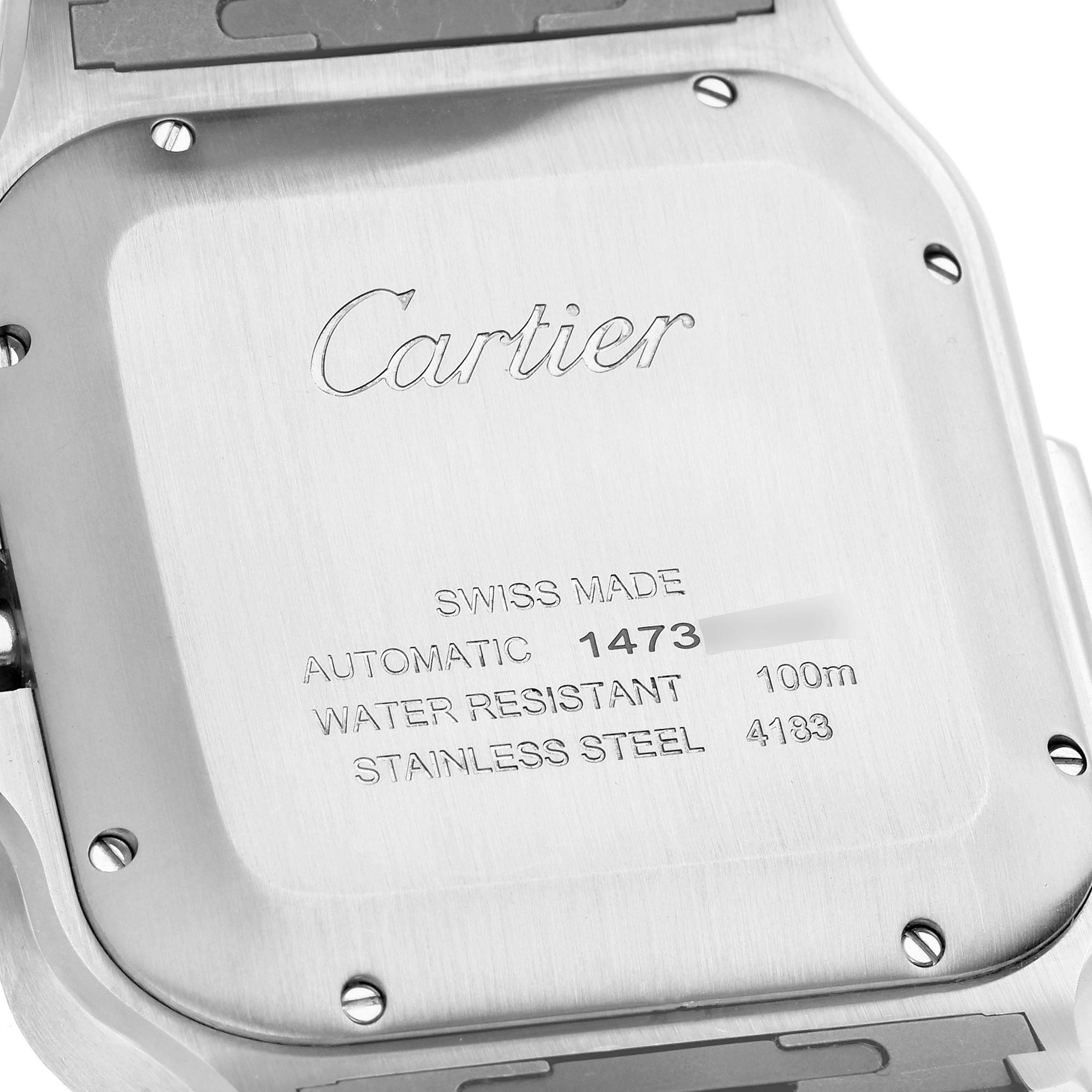 The image shows the back case of a Santos model Cartier watch, displaying the brand name, specifications, and serial numbers.
