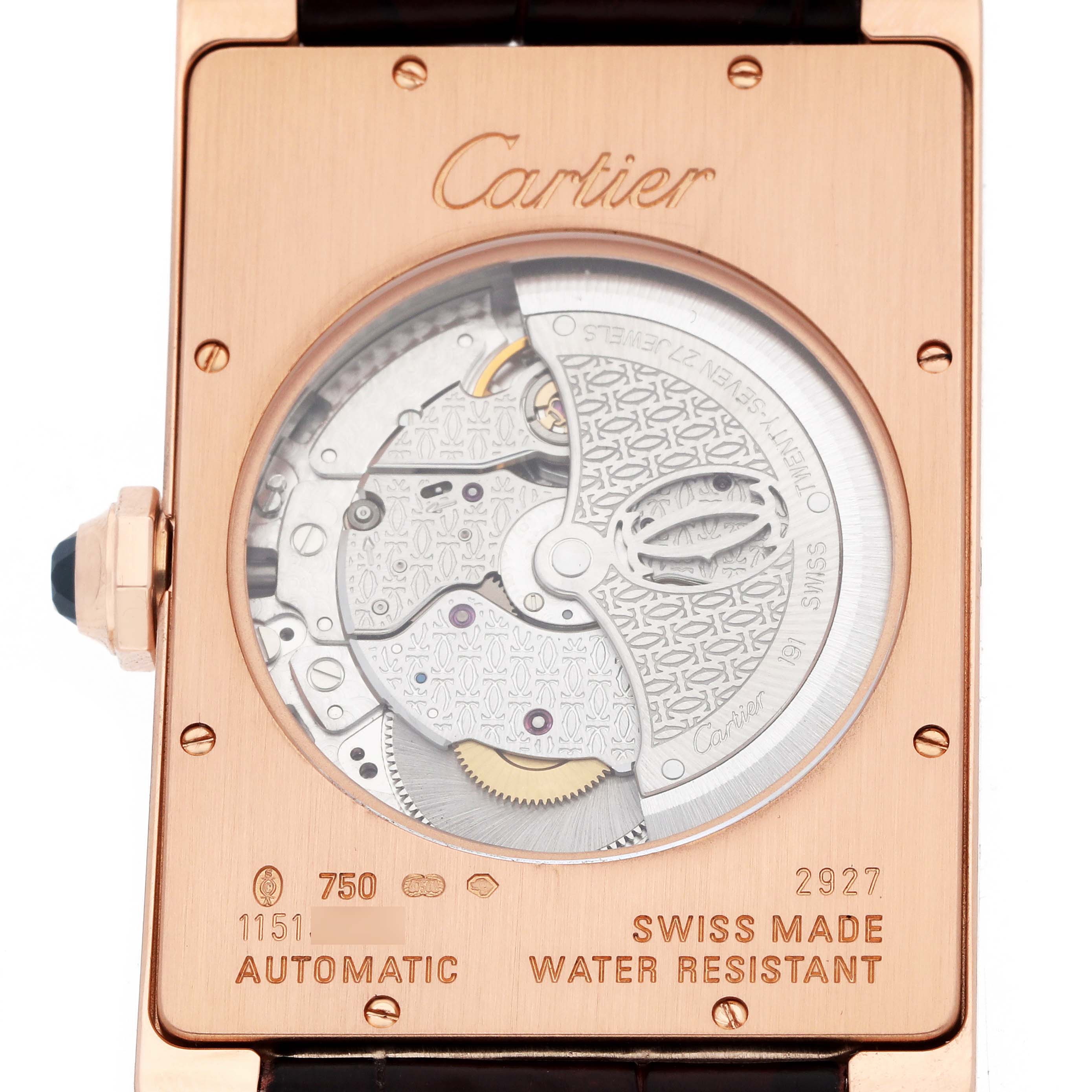 The image shows the back view of a Cartier Tank Américaine watch, highlighting its automatic movement and engravings.